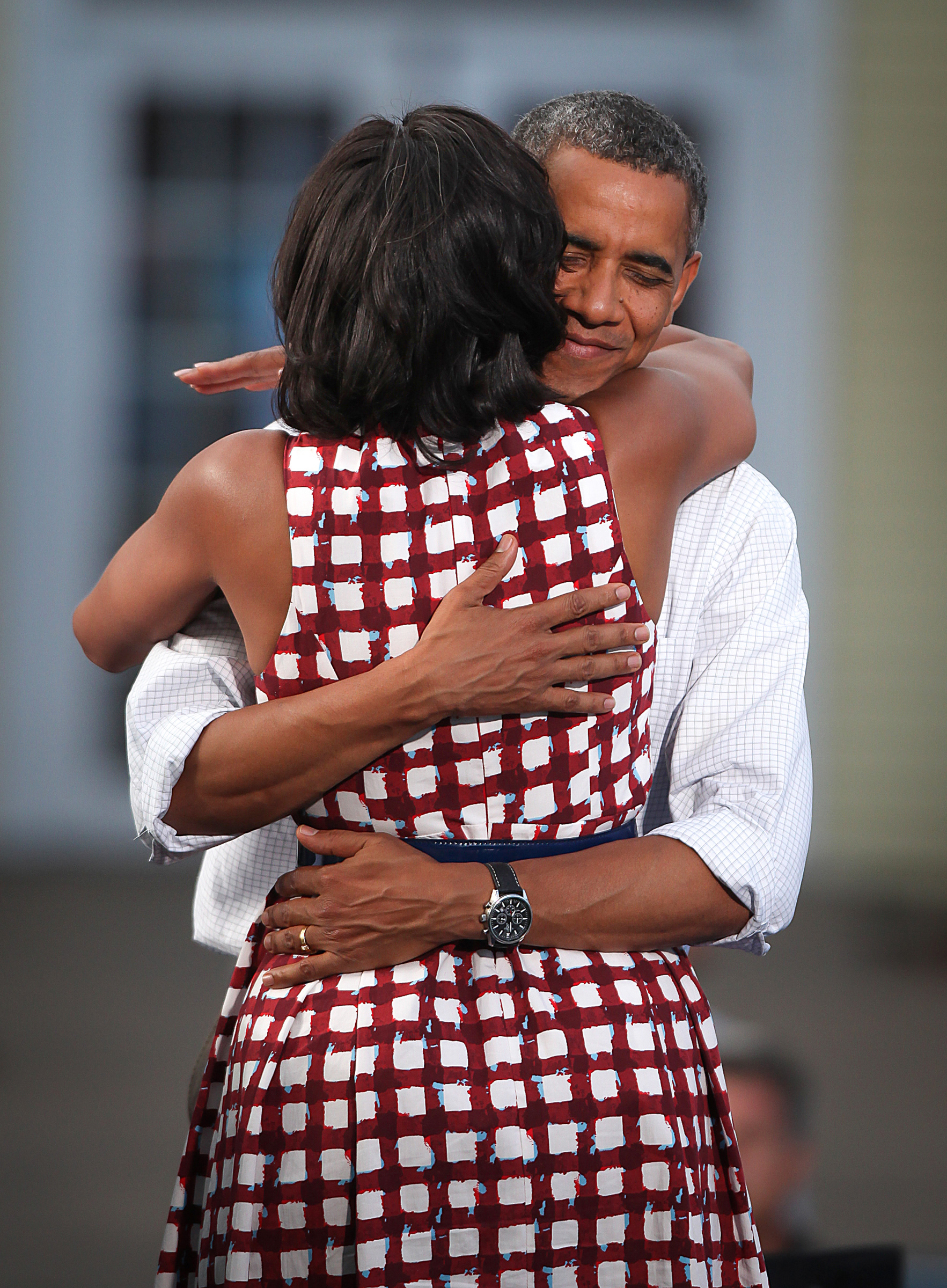 President Barack Obama and First Lady Michelle Obama greet the crowd of 3,000 supporters in downtown Davenport, Iowa, on Wednesday, Aug. 15, 2012. 