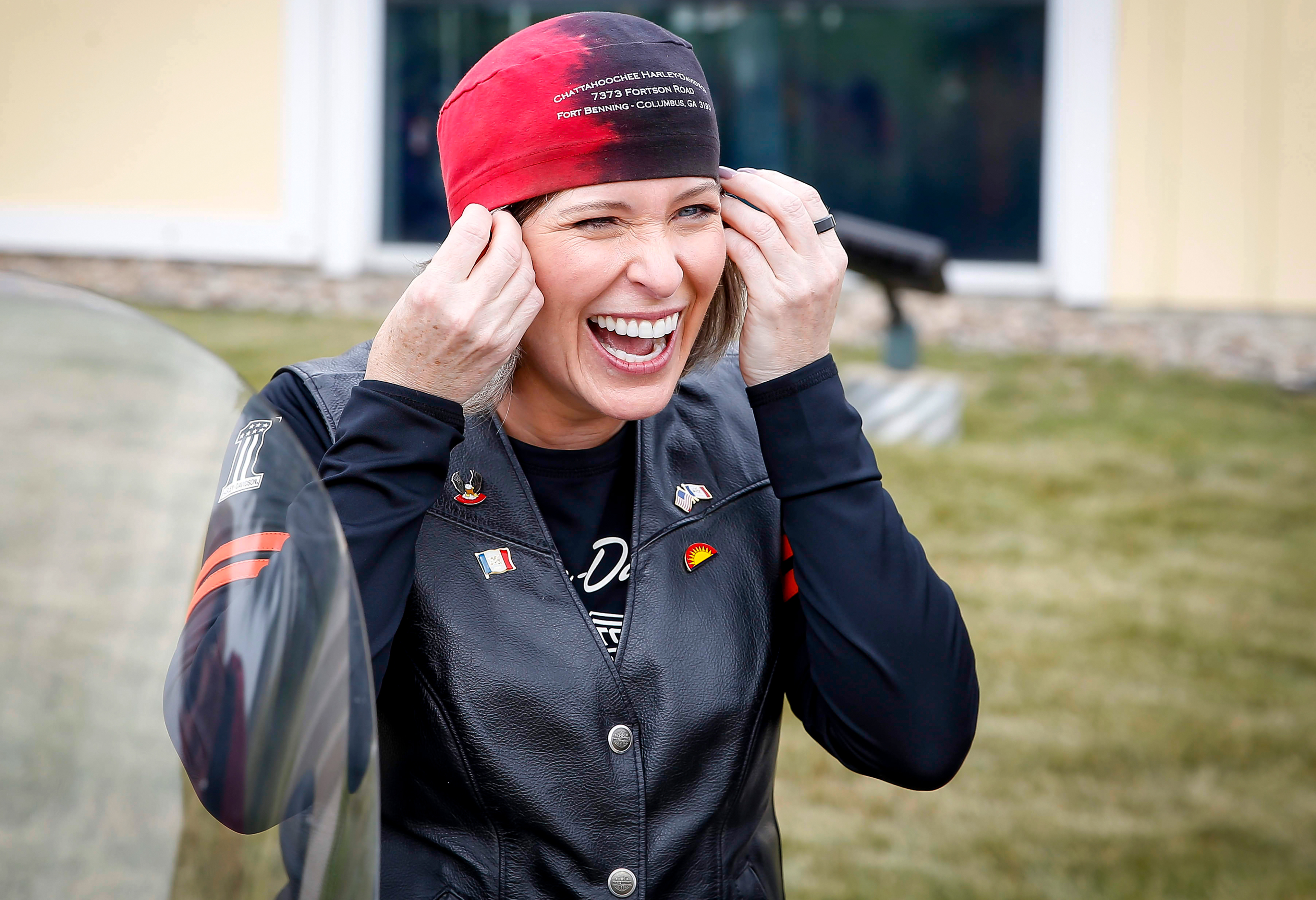 United States Sen. Joni Ernst (R-Iowa) pulls on a cap before leading the 5th annual Roast and Ride on Saturday, June 14, 2019, in Des Moines.