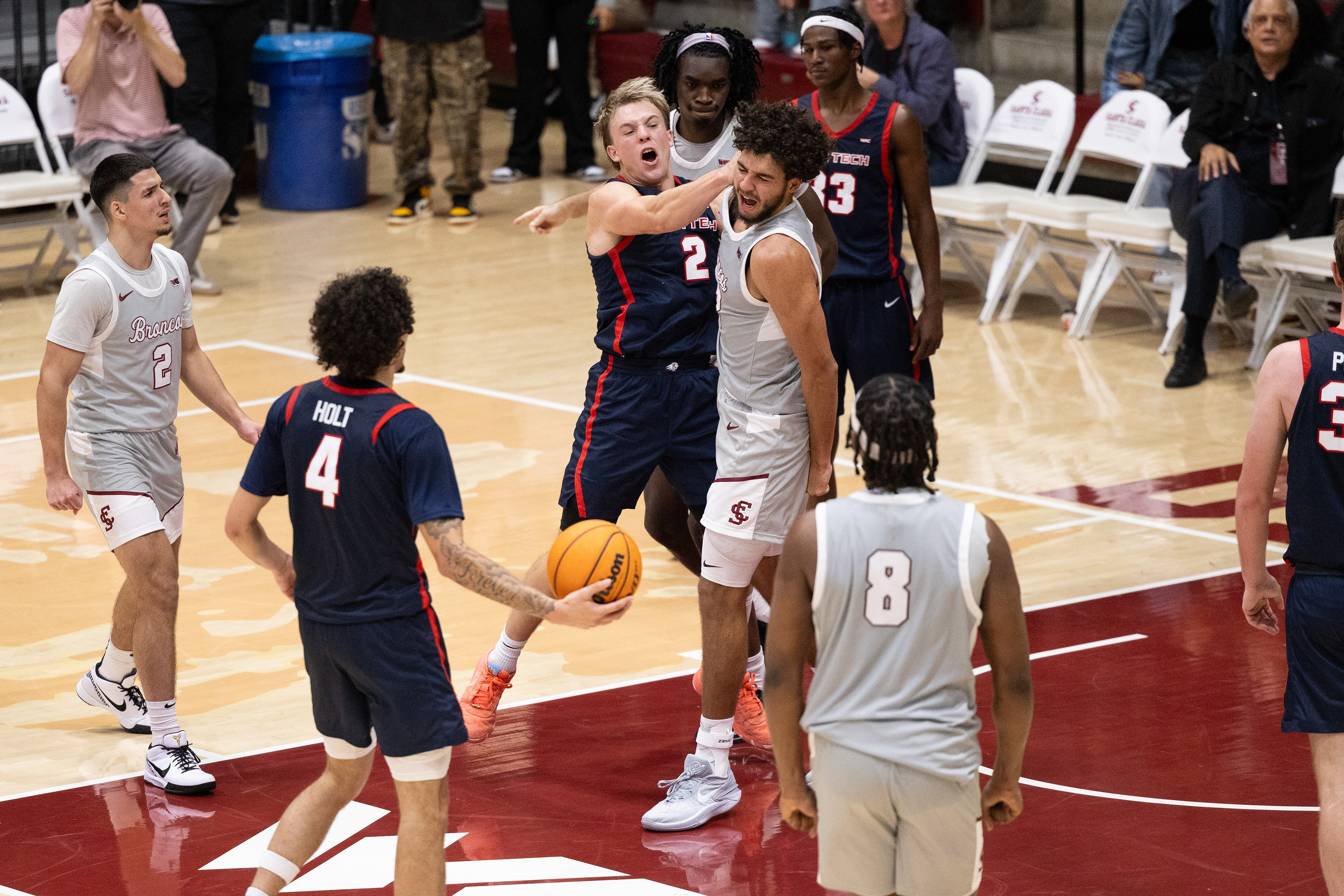 Utah State men’s basketball player Chance Trujillo (2) punches Santa Clara’s Allen Graves ’29 (22) after Graves dunked on Trujillo during Santa Clara men’s basketball’s game against Utah State on Wednesday, Dec. 3, 2025 at the Leavey Center in Santa Clara, Calif. (Nina Glick/The Santa Clara)
