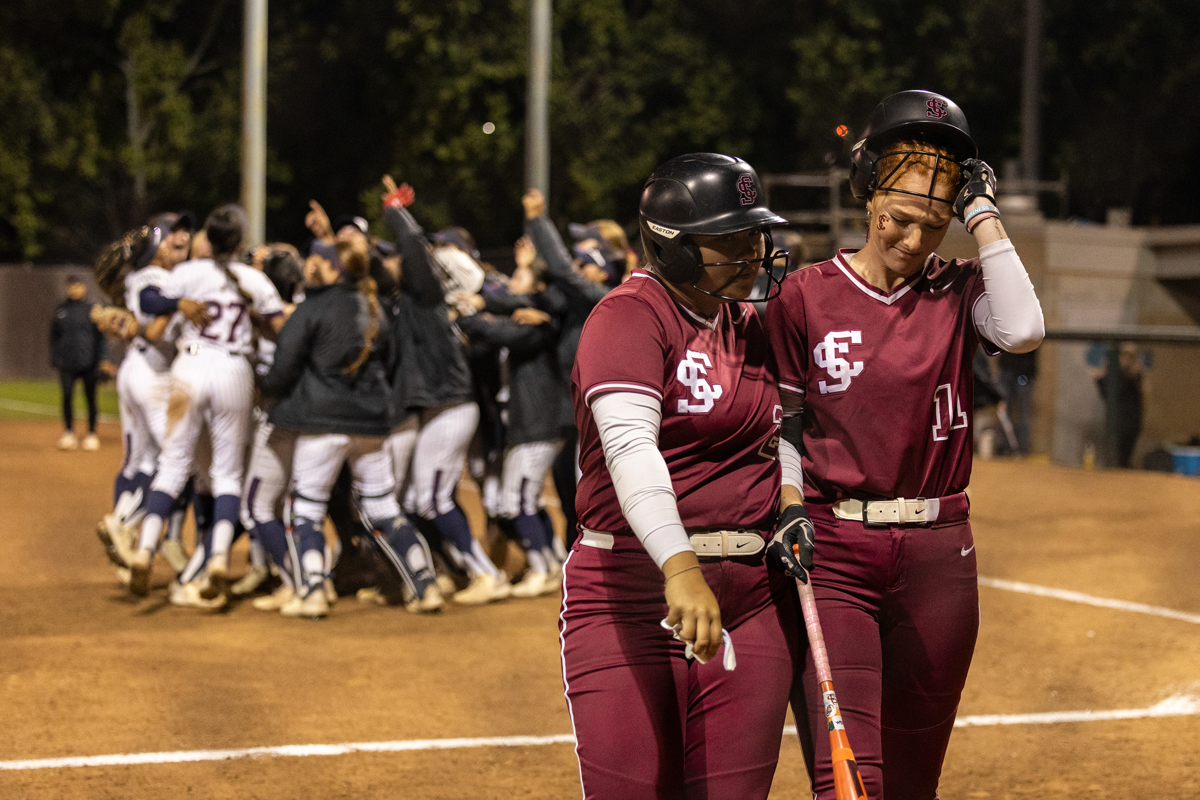 Santa Clara softball player Kyla Acres ’26 consoles Caitlyn Golob ’27 after Golob struck out ending the game in the seventh and final inning of Santa Clara softball’s game against Saint Mary’s at Santa Clara Softball Stadium on Friday, May 8, 2026. With the 7-4 win against the Broncos, Saint Mary’s won the West Coast Conference. Santa Clara had to win the game on Friday and another on Saturday against the Gaels to win the conference title. (Nina Glick/The Santa Clara) 