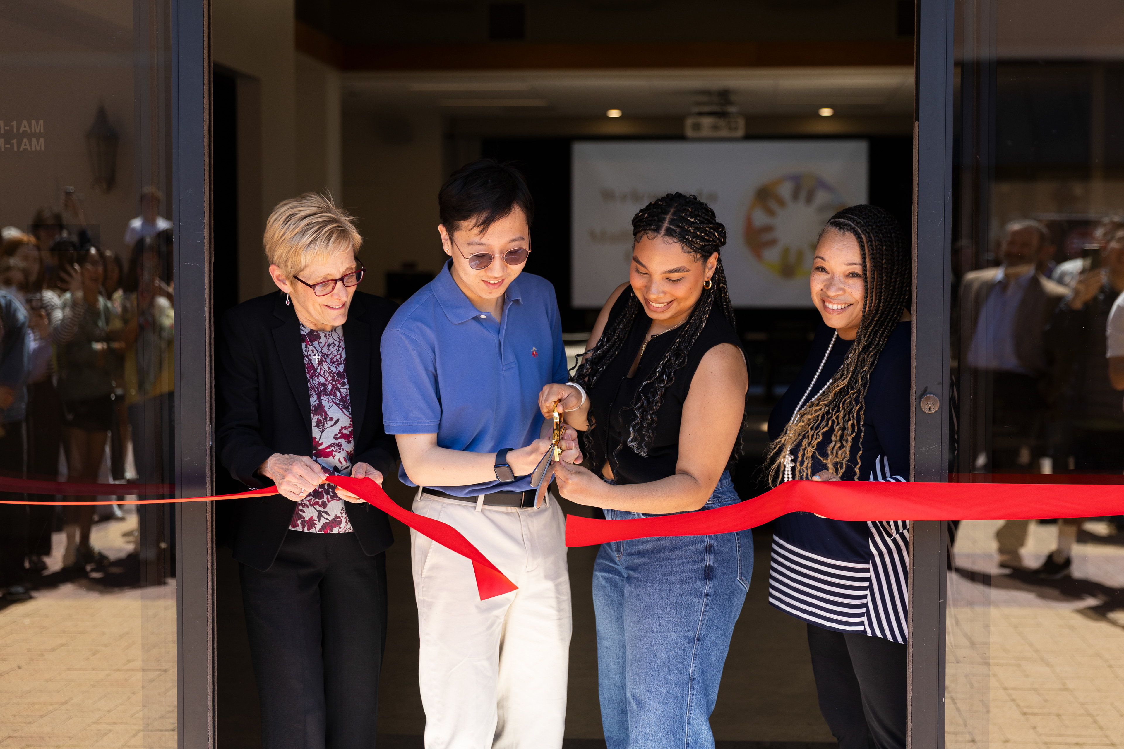 Santa Clara University President Julie Sullivan, leaders of Santa Clara University's Multicultural Center Denae Rivera ’25 and Kenneth Park ’25, and Vice President for Inclusive Excellence Shá Duncan Smith, take part in a ribbon cutting for the newly renovated Shapell Lounge at Santa Clara University. 