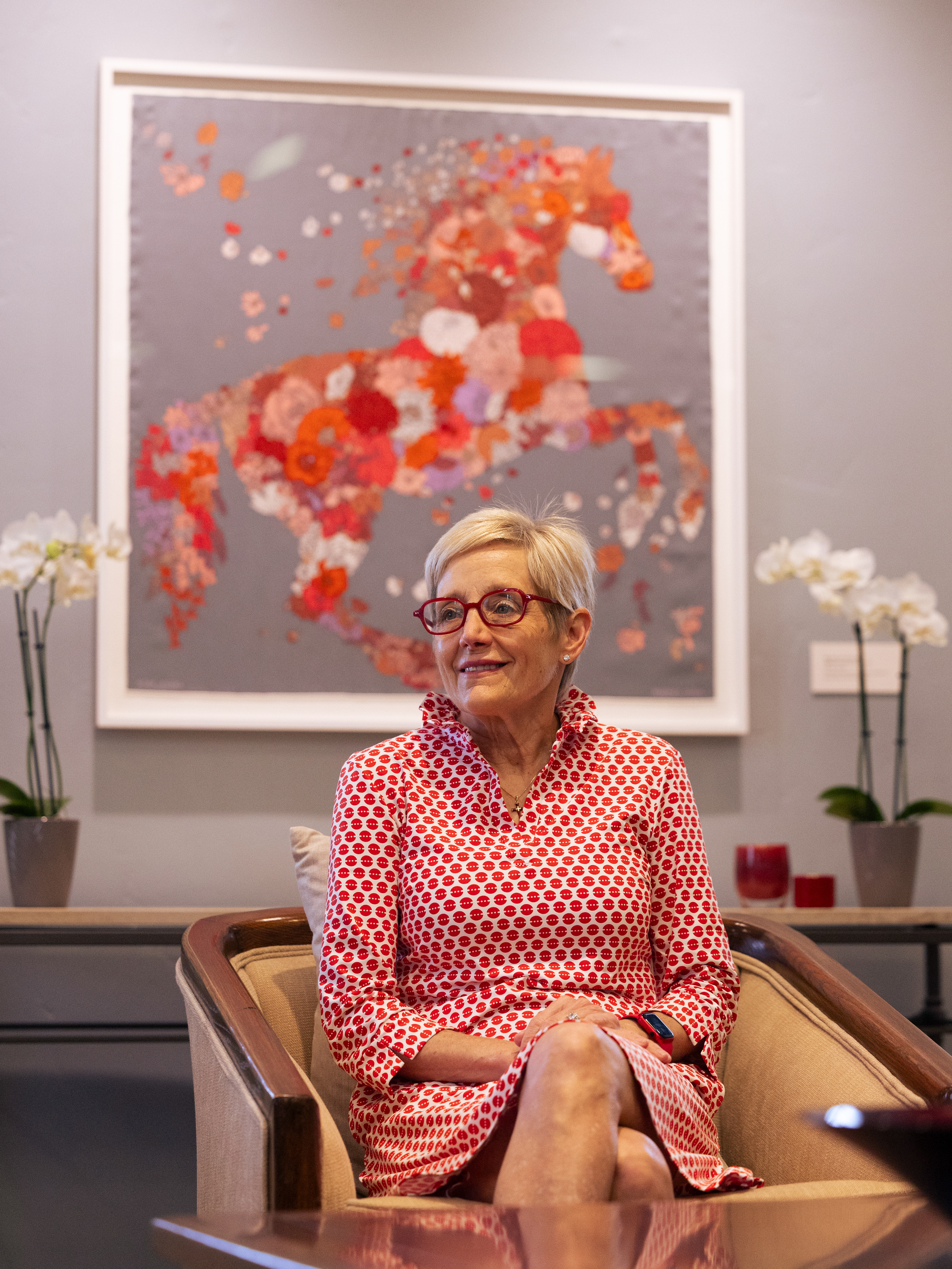 Santa Clara University President Julie Sullivan sits in her office in the Walsh Administration Building on Friday, May 29, 2026, in front of a framed scarf given to her by women who were on the Santa Clara University Board of Trustees early in her tenure as president of the University. (Nina Glick/The Santa Clara)
