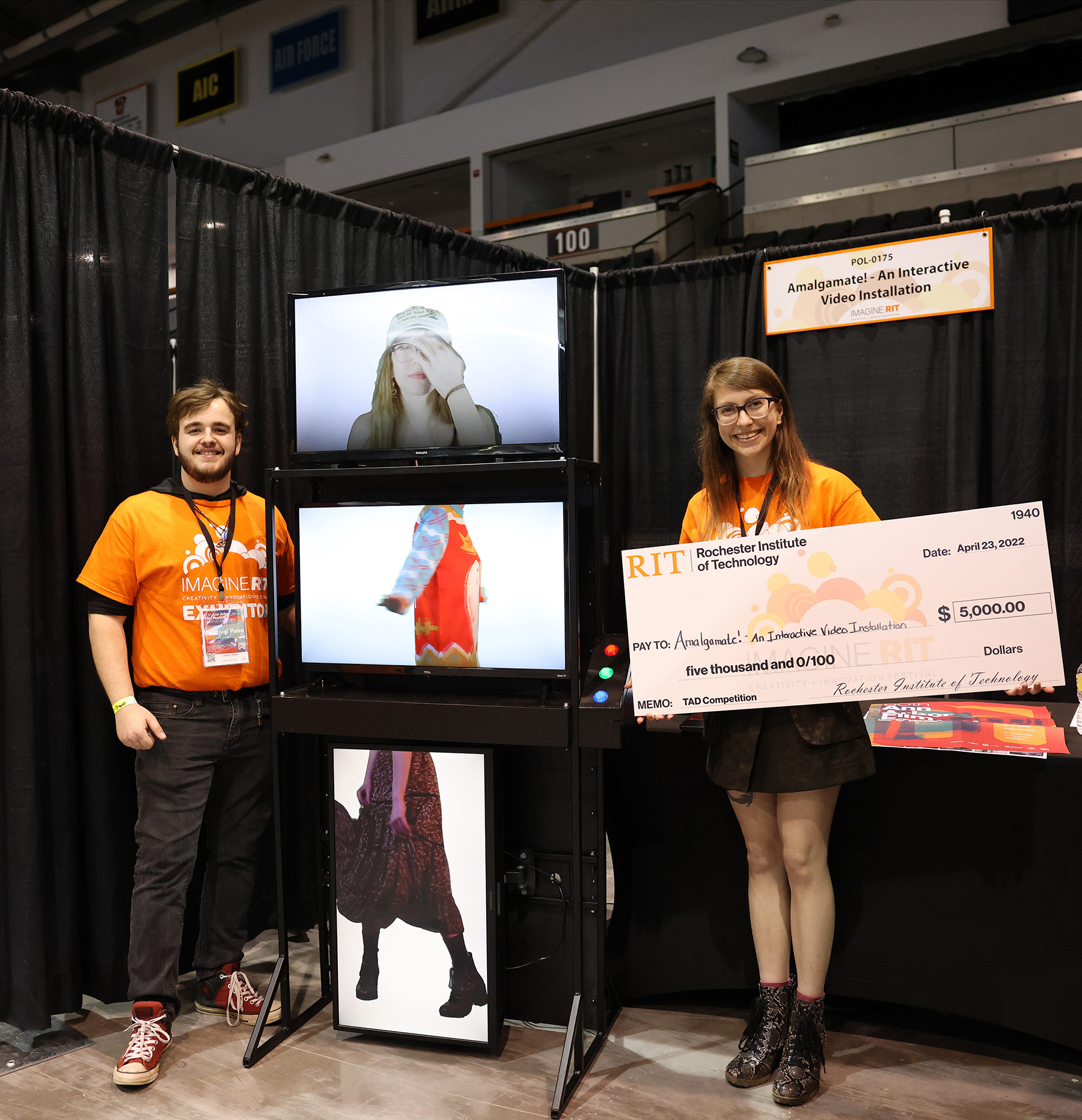 Johnny Gates, left, and Alexandra McDonald, right, accept the award for "Amalgamate" being a category winner in Imagine RIT's Technology, the Arts and Design (TAD) competition