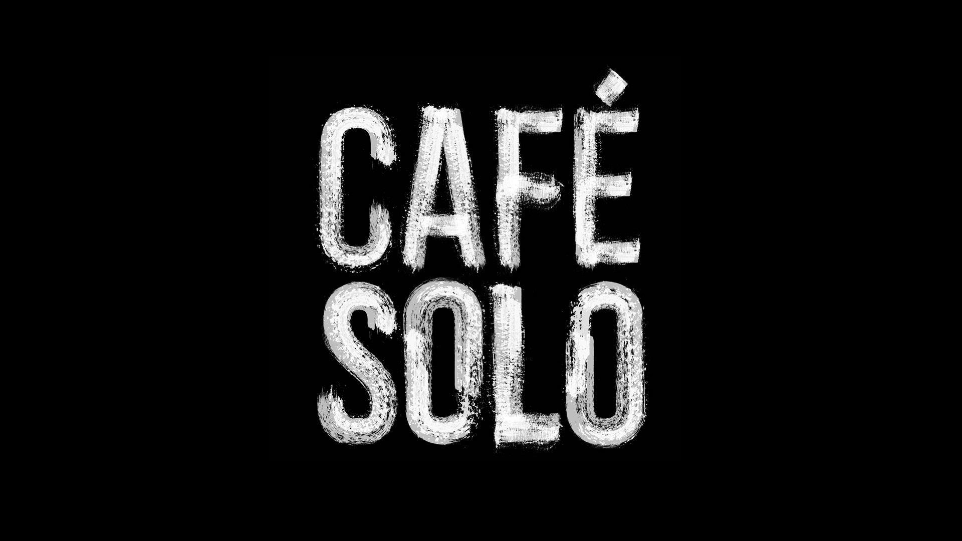 CAFE SOLO logo. a monochromatic wordmark inspired by 1980s culture and textured to look like special applied marks found on European fortified wine bottles.