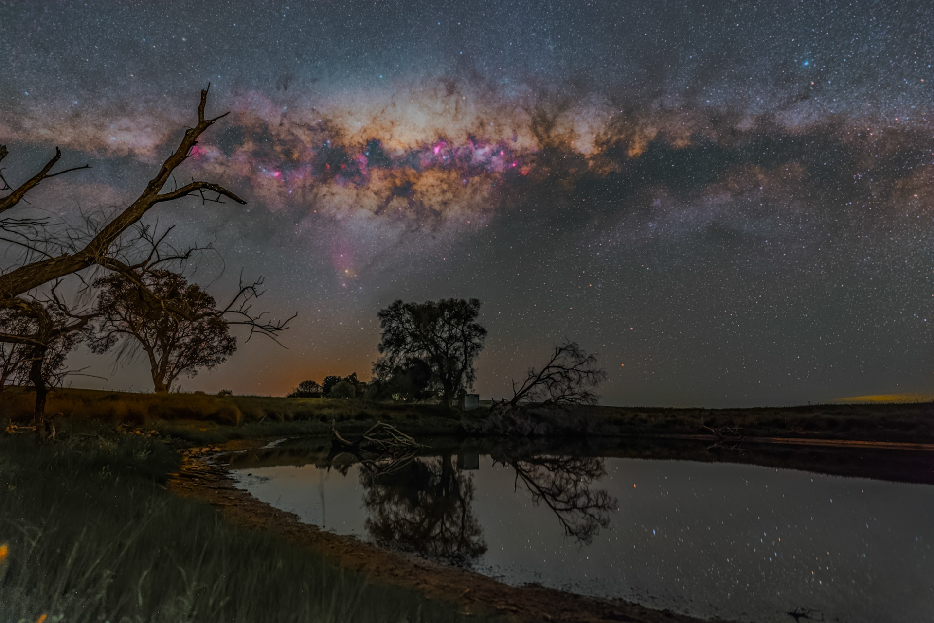 Milky Way over a lake near Canola Fields