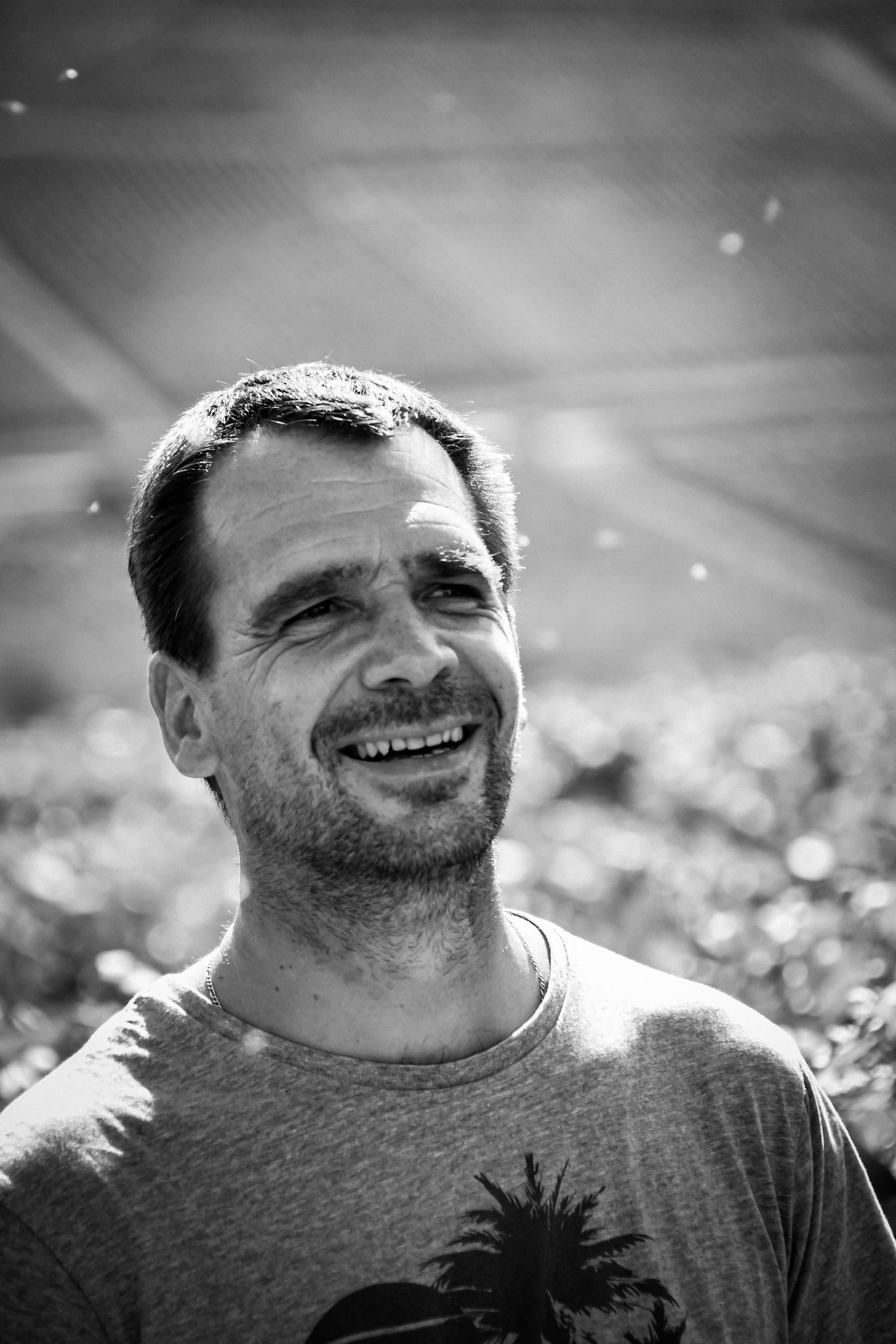 Relaxed outdoor portrait of a man photographed in natural light.