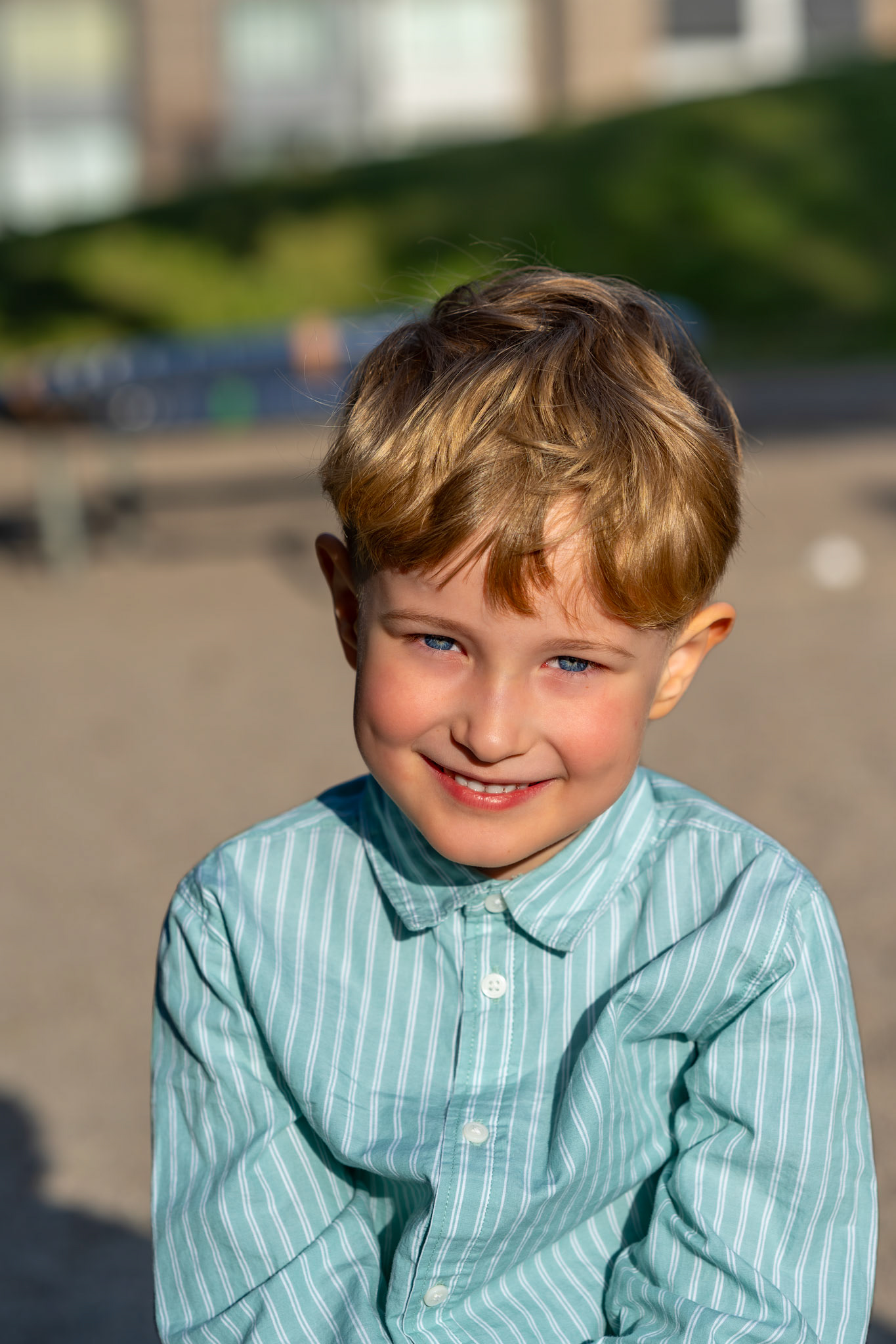 Natural-light colour portrait of a smiling child outdoors.