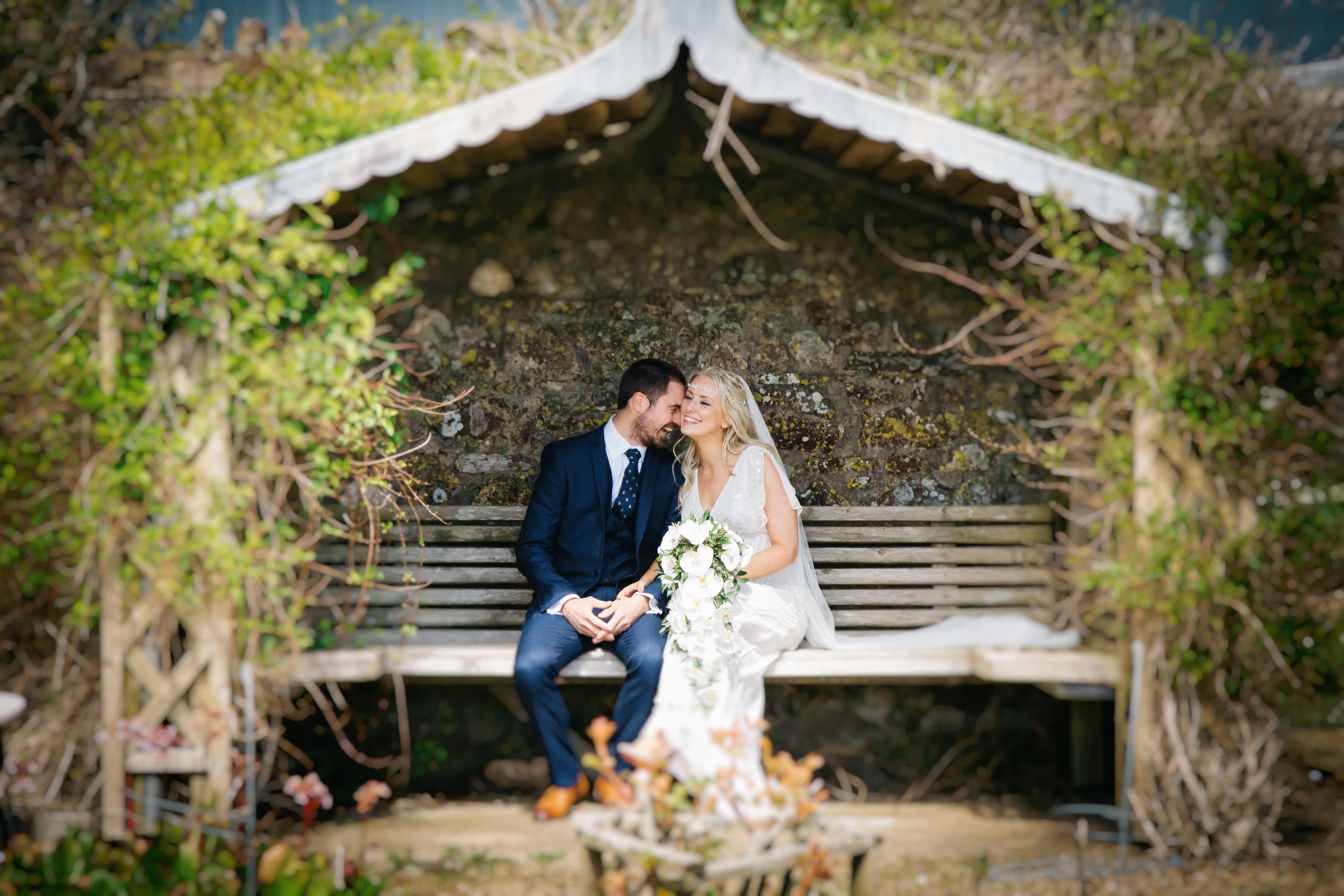 Bride and Groom sat on a bench
