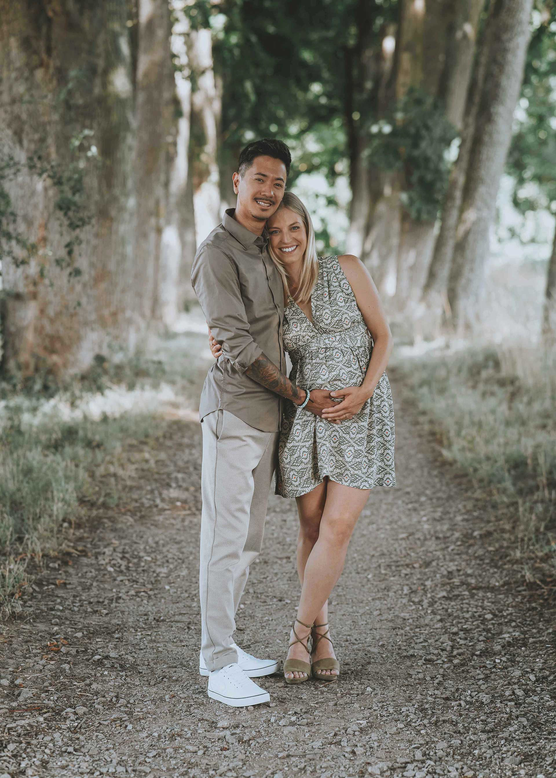 Inniges Porträt eines Paares beim Babybauch-Fotoshooting im Freien mit Fokus auf die Vorfreude