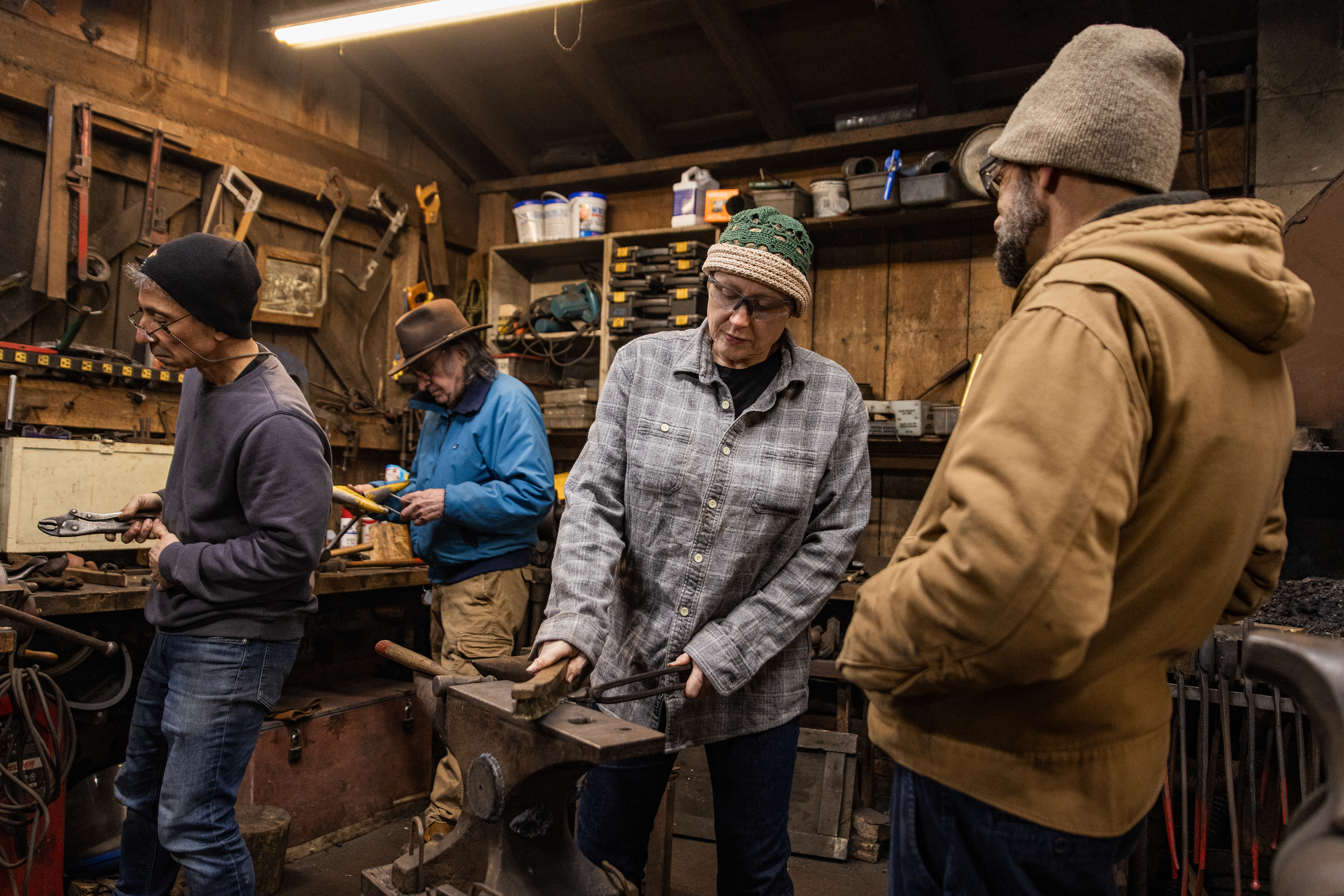 Marnie Dollinger, president of the Blacksmiths Guild of the Potomac, guides a student through the process of making a snowflake at the forge in Arlington, Va. on Dec. 03, 2025.