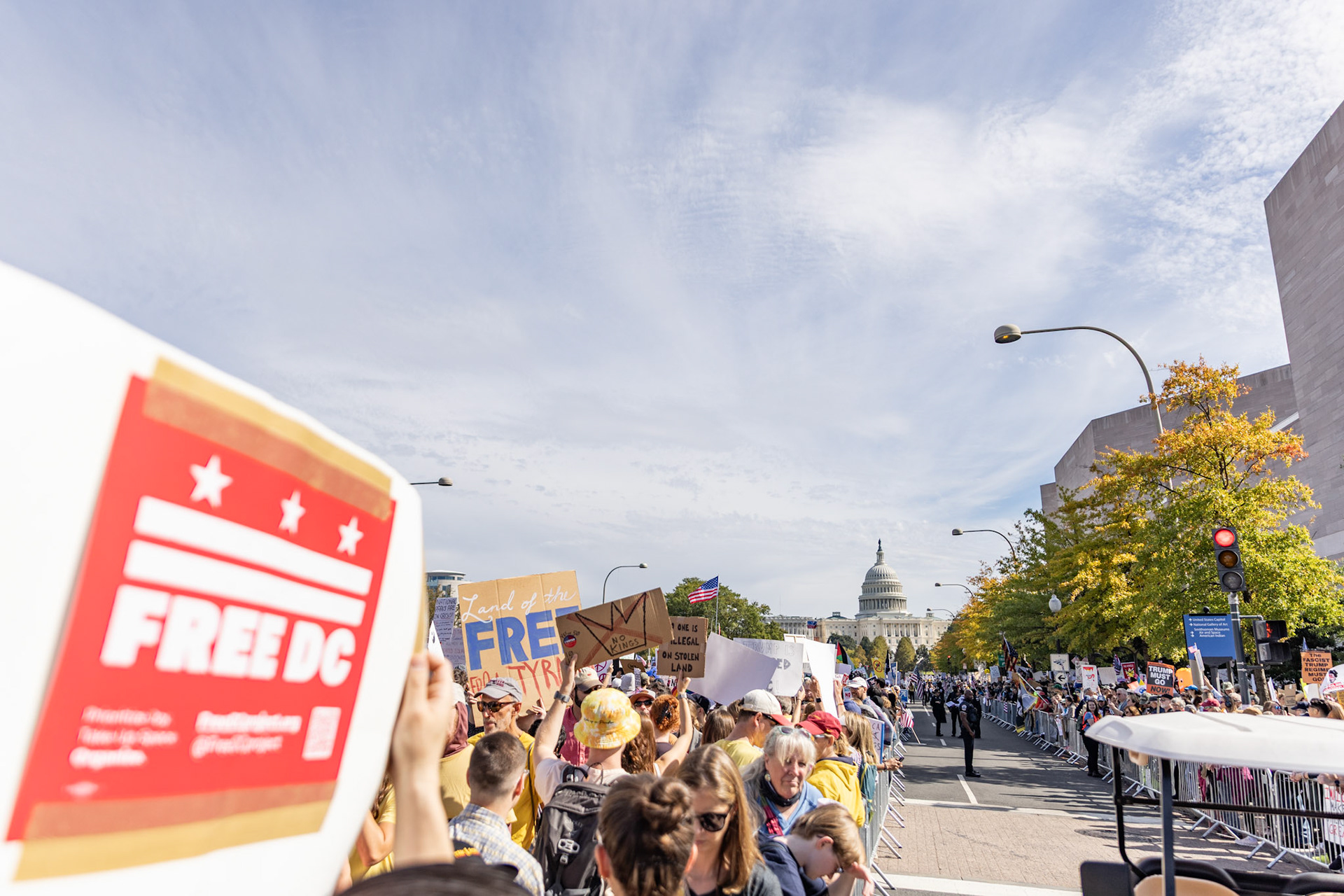Protestors line barriers along Pennsylvania Avenue during the No Kings protest in Washington, D.C. on Oct. 18, 2025. Over 7 million people across the country marched against recent actions by President Trump, from the immigration crackdown to the general state of the economy.