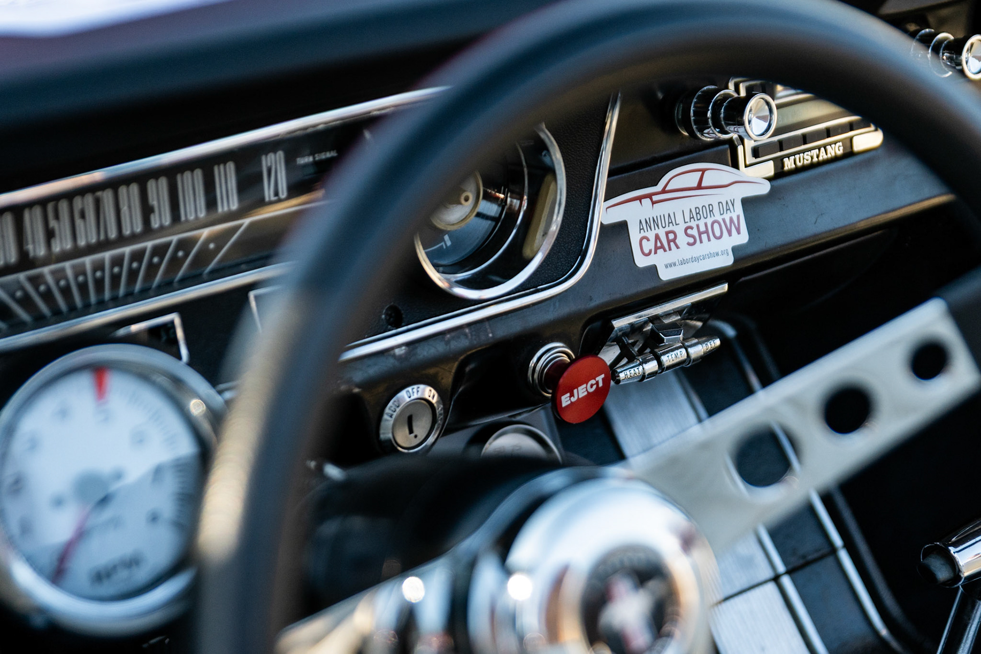 FAIRFAX, VIRGINIA - SEPTEMBER 01: A sticker honoring the Fairfax County Labor Day Car Show is displayed on the dashboard of a Mustang during the event on September 1, 2025. The show, welcoming families from around the area to celebrate Labor Day and support local charities, featured over 250 vehicles competing for a variety of awards.