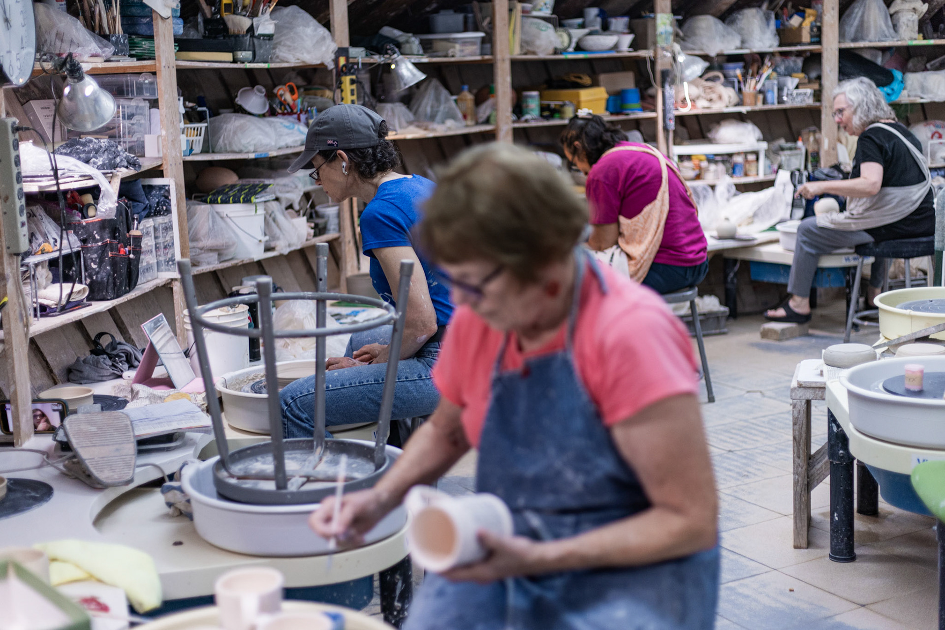 Members of Glen Echo Pottery throw their pieces on the wheel, the first step in the creation process, at the studio in Glen Echo, Md. on Sept. 28, 2025.