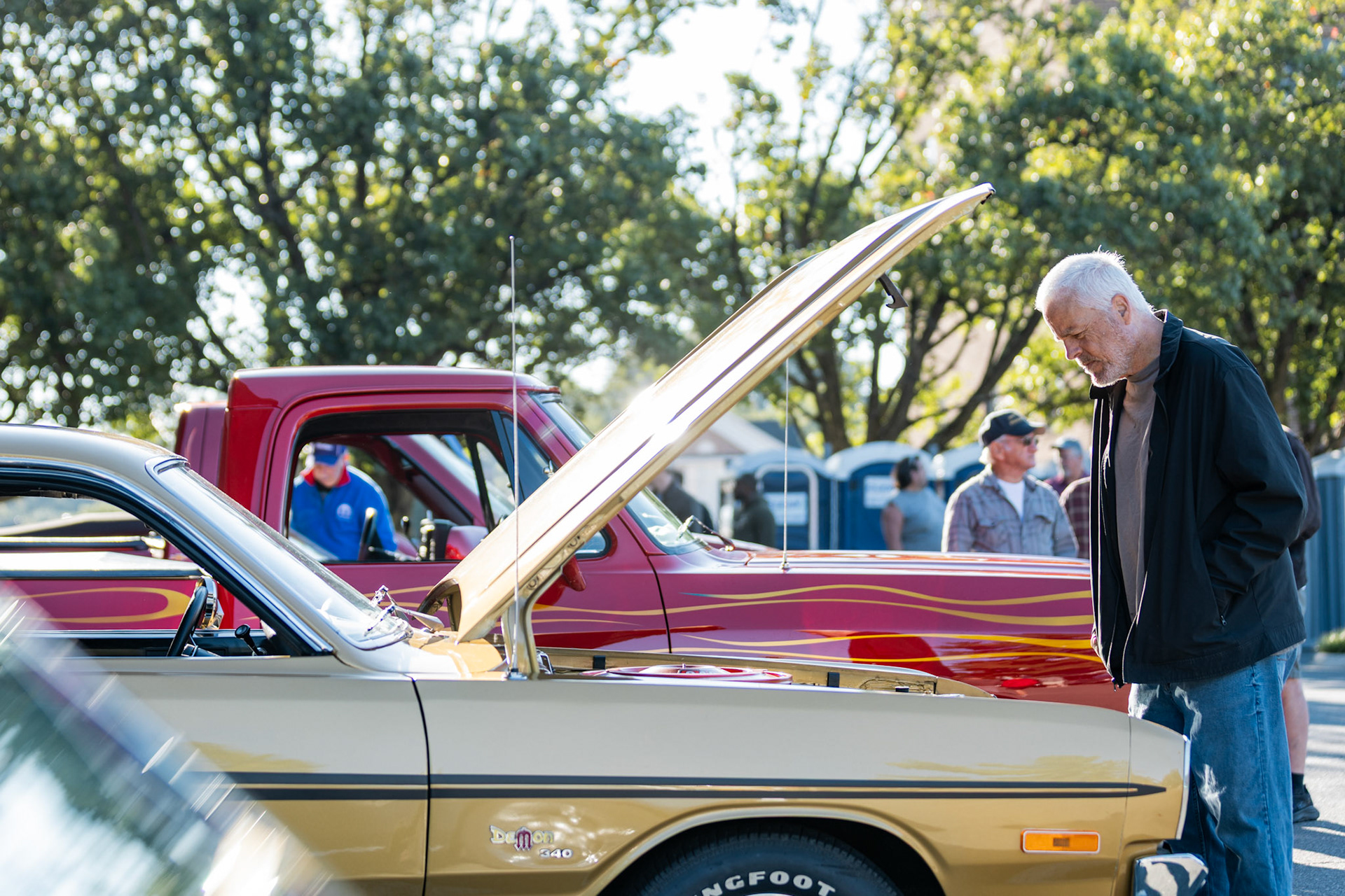 FAIRFAX, VIRGINIA - SEPTEMBER 01: An attendee at the 26th Annual Fairfax County Labor Day Car Show looks at the engine of a Dodge Demon 340 on September 1, 2025. The show, welcoming families from around the area to celebrate Labor Day and support local charities, featured over 250 vehicles competing for a variety of awards.