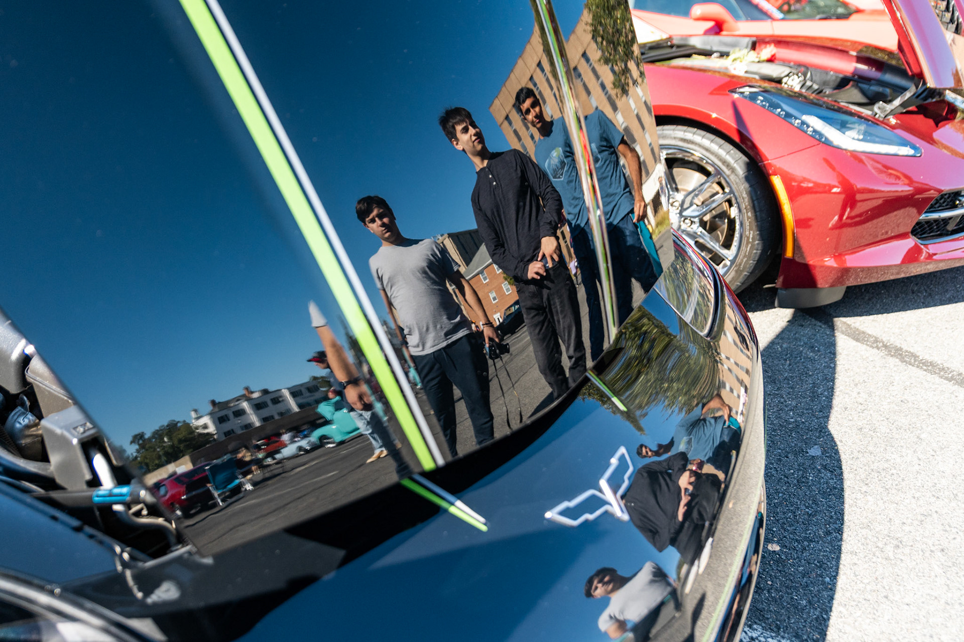 FAIRFAX, VIRGINIA - SEPTEMBER 01: Attendees at the 26th Annual Fairfax County Labor Day Car Show look at a 2008 Chevrolet Corvette competing for the title of Best Chevy on September 1, 2025. The show, welcoming families from around the area to celebrate Labor Day and support local charities, featured over 250 vehicles competing for a variety of awards.