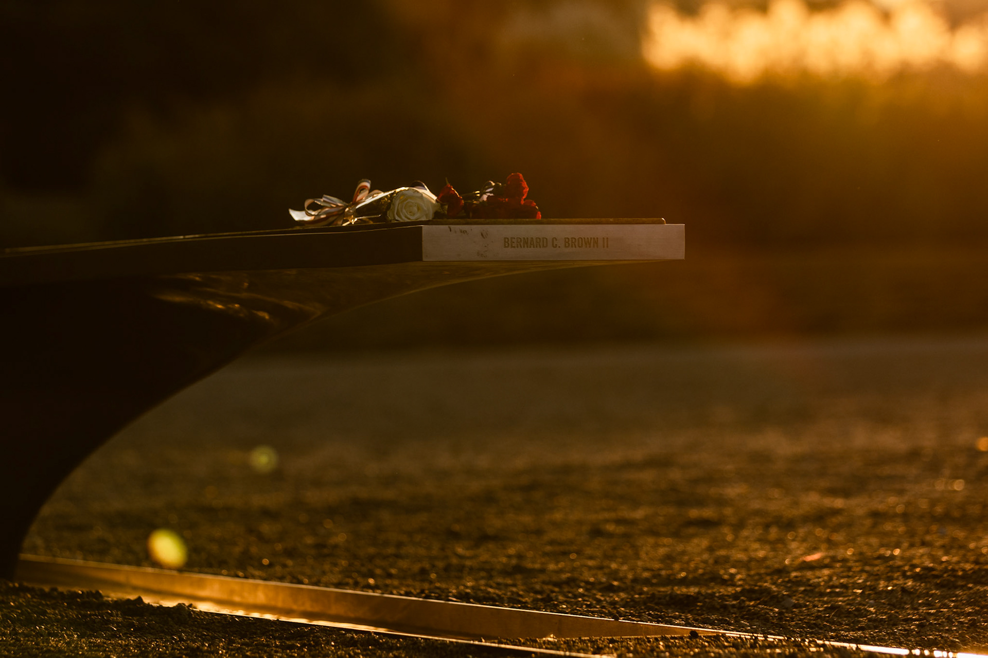 ARLINGTON, VIRGINIA - SEPTEMBER 11: The sun sets over a bench dedicated to Bernard C. Brown II at the Pentagon 9/11 Memorial on Sept. 11, 2025. Browne was an 11 year old student from Southeast Washington, D.C. aboard American Airlines flight 77 to Los Angeles, California as part of a trip sponsored by the National Geographic Society.
