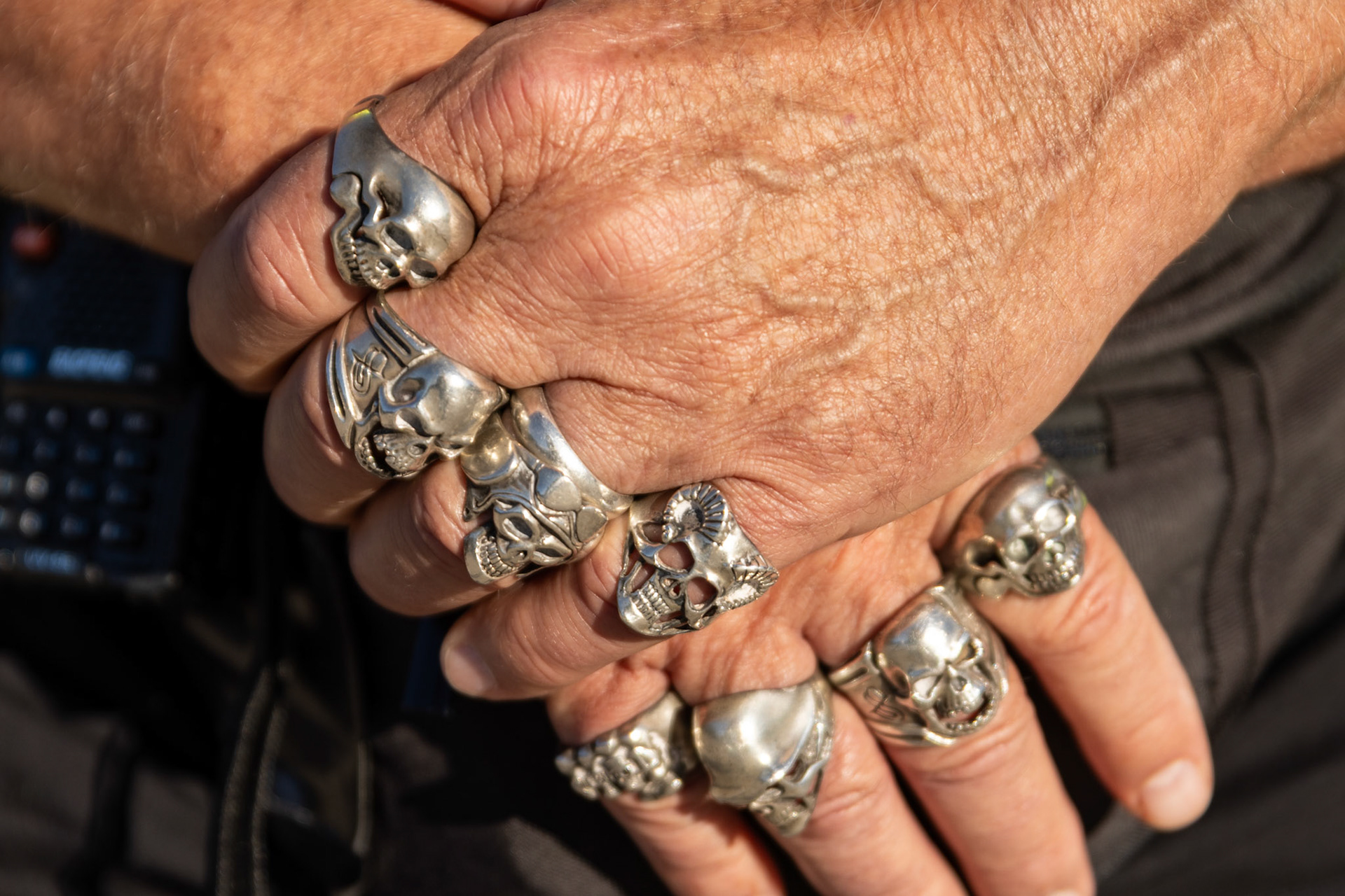 A volunteer at the Washington, D.C. Unite the DMV rally dons skull rings on Oct. 17, 2025. The protest, which featured speakers and dancing, brought together government employees, citizens, and veterans in an effort to defend democracy on the eve of the No Kings protests.