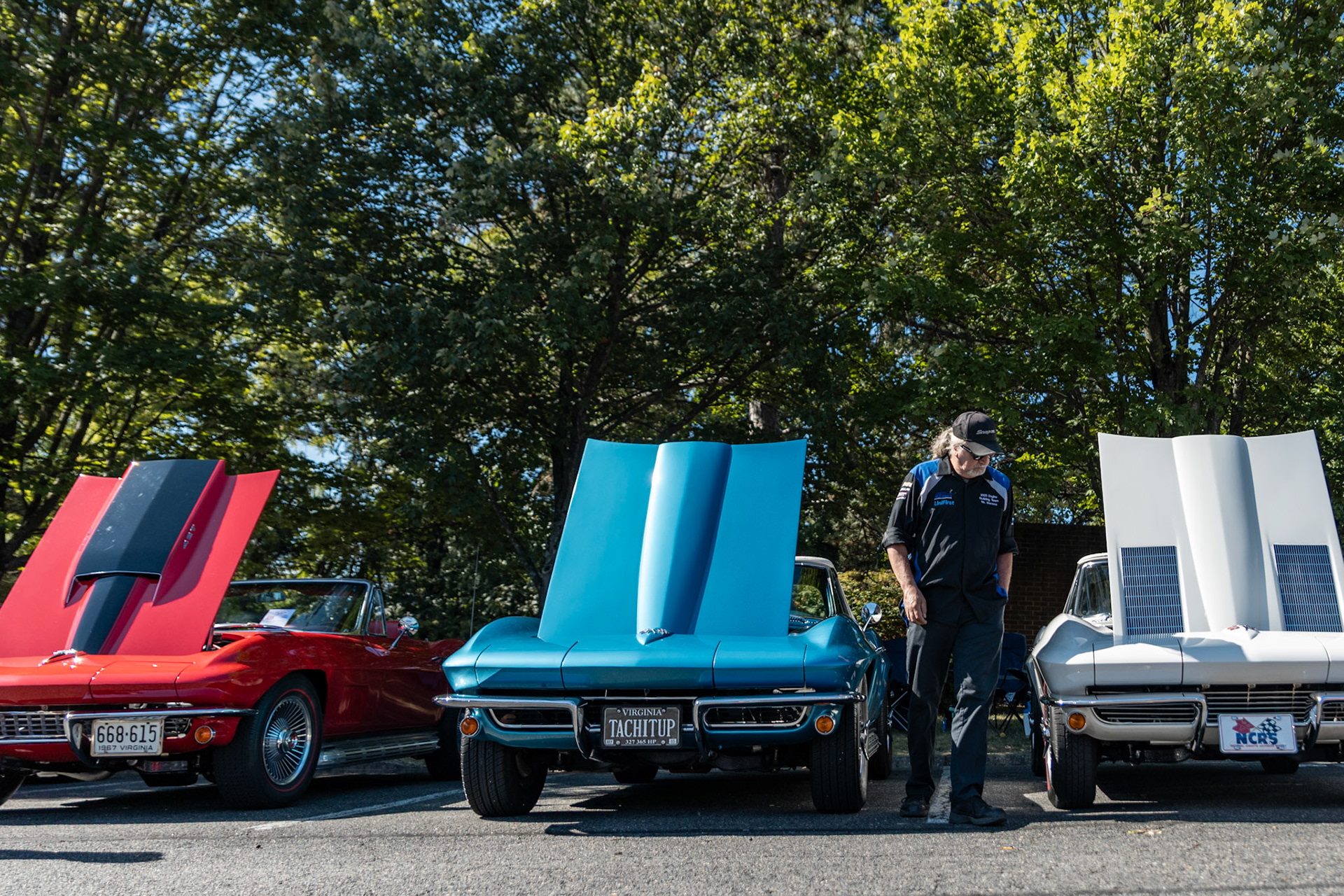 FAIRFAX, VIRGINIA - SEPTEMBER 01: An attendee at the 26th Annual Fairfax County Labor Day Car Show walks through a line up of vintage Chevrolet Corvettes on September 1, 2025. The show, welcoming families from around the area to celebrate Labor Day and support local charities, featured over 250 vehicles competing for a variety of awards.
