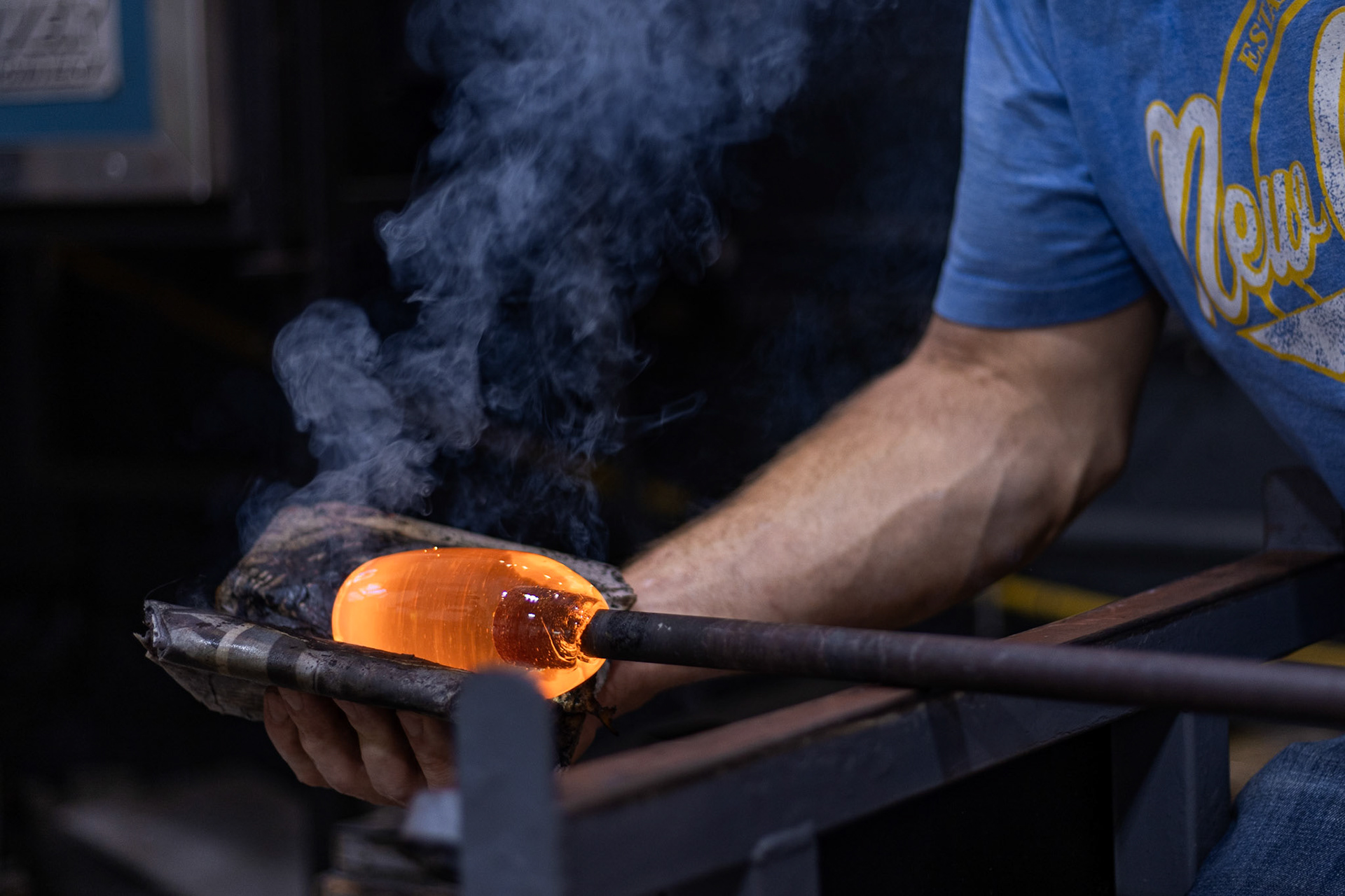 Paul Swartwood, owner of Glen Echo Glassworks, rounds out molten glass to serve as the base for a pumpkin figurine in his studio in Glen Echo, Md. on Oct. 01, 2025.