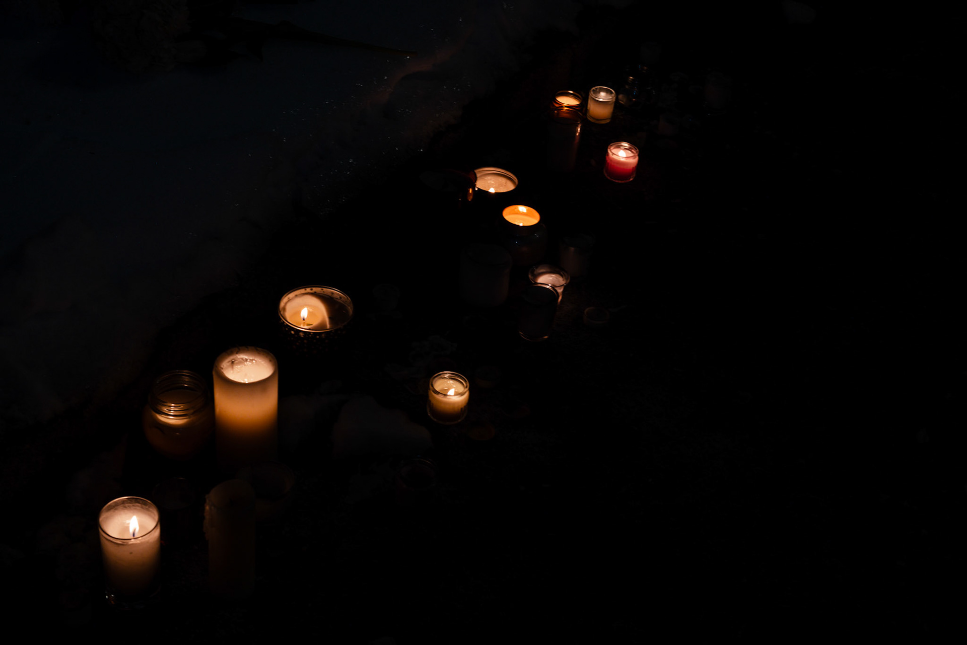 Candles line the sidewalk in front of the Department of Veteran Affairs headquarters during a vigil honoring Alex Pretti in Washington, D.C. on Jan. 28, 2026. Hundreds gathered here, and across the country, to honor his life and legacy after he was shot and killed by Border Patrol agents in Minneapolis days prior.