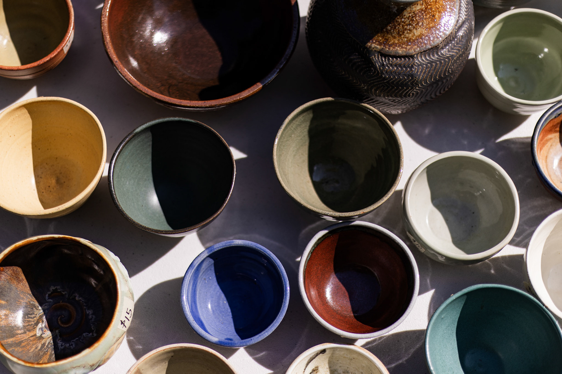 Handmade bowls created by members of Glen Echo Pottery are displayed along a table during the Echo Arts Festival on Sept. 28, 2025 in Glen Echo, Md.
