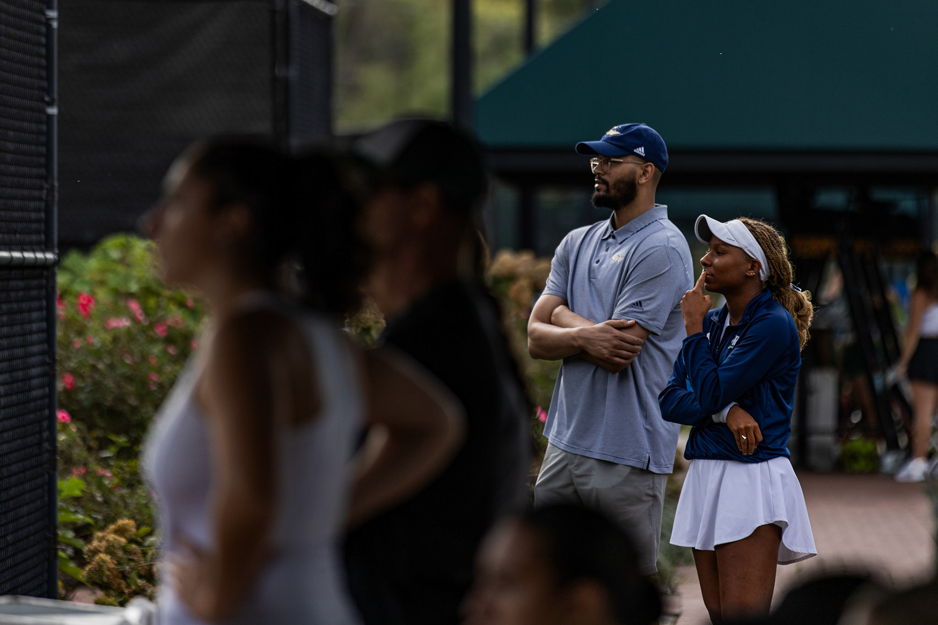 COLLEGE PARK, MARYLAND - SEPTEMBER 20: GW junior Solange Skeene watches her teammates matches during the Bedford Cup tournament in College Park, Md. on Sept. 20, 2025. Under the direction of new Head Coach Jackie Calla, the tennis team ended with four singles bracket wins and one doubles bracket win.