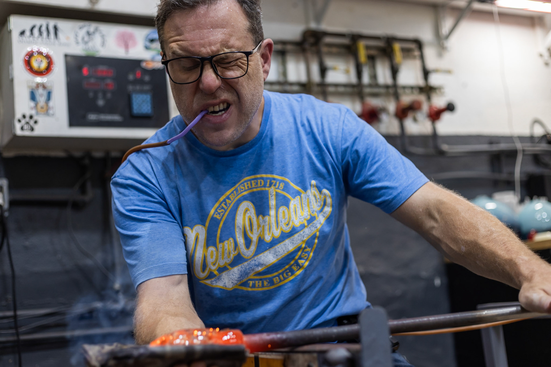 Paul Swartwood, owner of Glen Echo Glassworks, blows air through the pipe to inflate a piece of glass into a pumpkin on Oct. 01, 2025 in Glen Echo, Md.