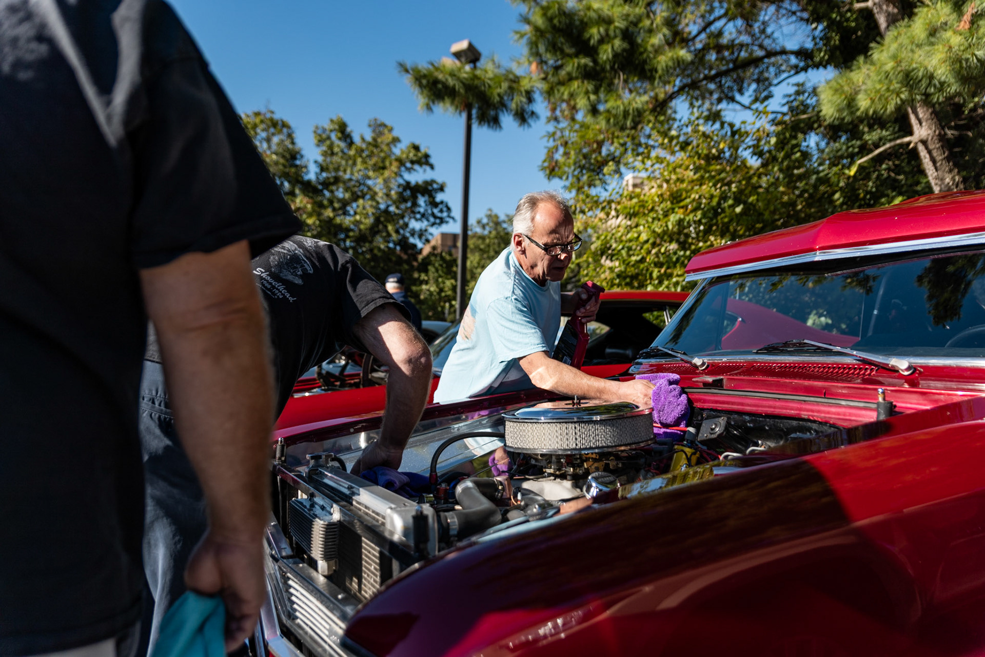 FAIRFAX, VIRGINIA - SEPTEMBER 01: The owner of a Chevrolet Chevy II shines the engine as the 26th Annual Fairfax County Labor Day Car Show kicks off on September 1, 2025. The show, welcoming families from around the area to celebrate Labor Day and support local charities, featured over 250 vehicles competing for a variety of awards.
