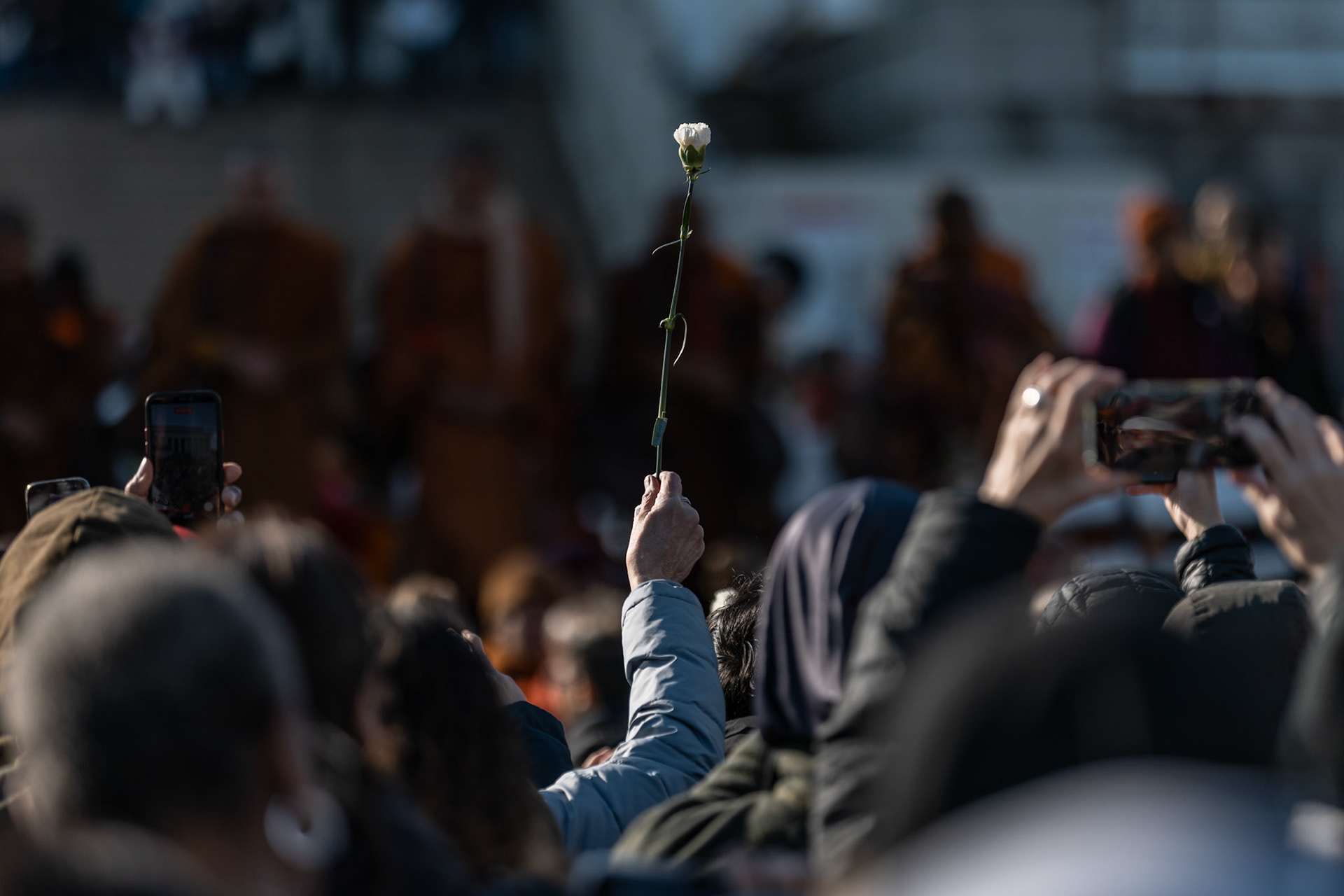 A supporter holds up a carnation as the monks deliver final remarks on day 109 of the Walk for Peace in front of the Lincoln Memorial on Feb. 11, 2026. A group of 18 monks began their march to raise awareness of “peace, loving kindness and compassion” in the United States and the world on Oct. 26 in Fort Worth, Texas, ending with their arrival in the nation's capital.