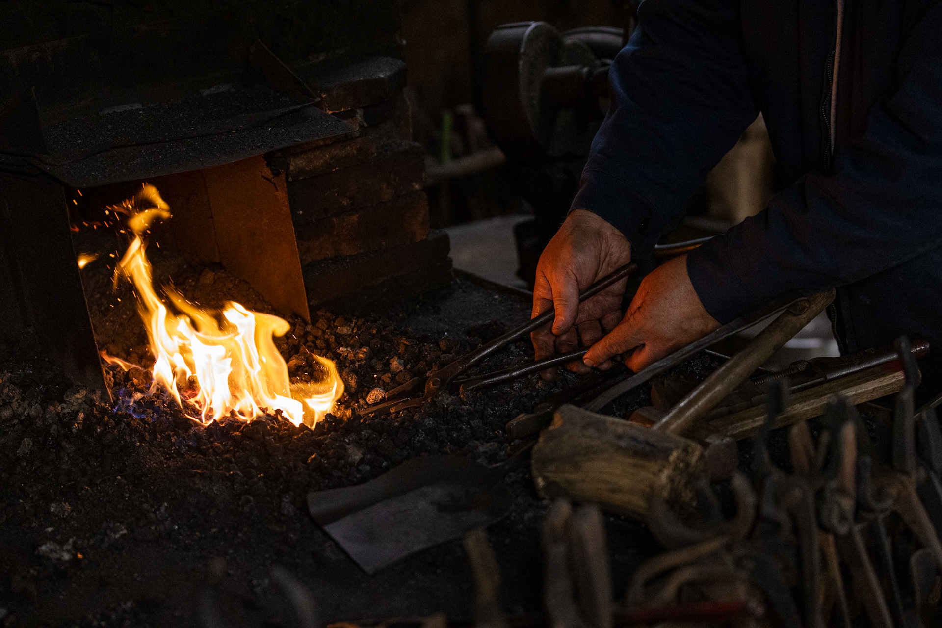A member of the Blacksmiths Guild of the Potomac heats an iron rod in the forge during a guild meeting in Arlington, Va. on Nov. 07, 2025.