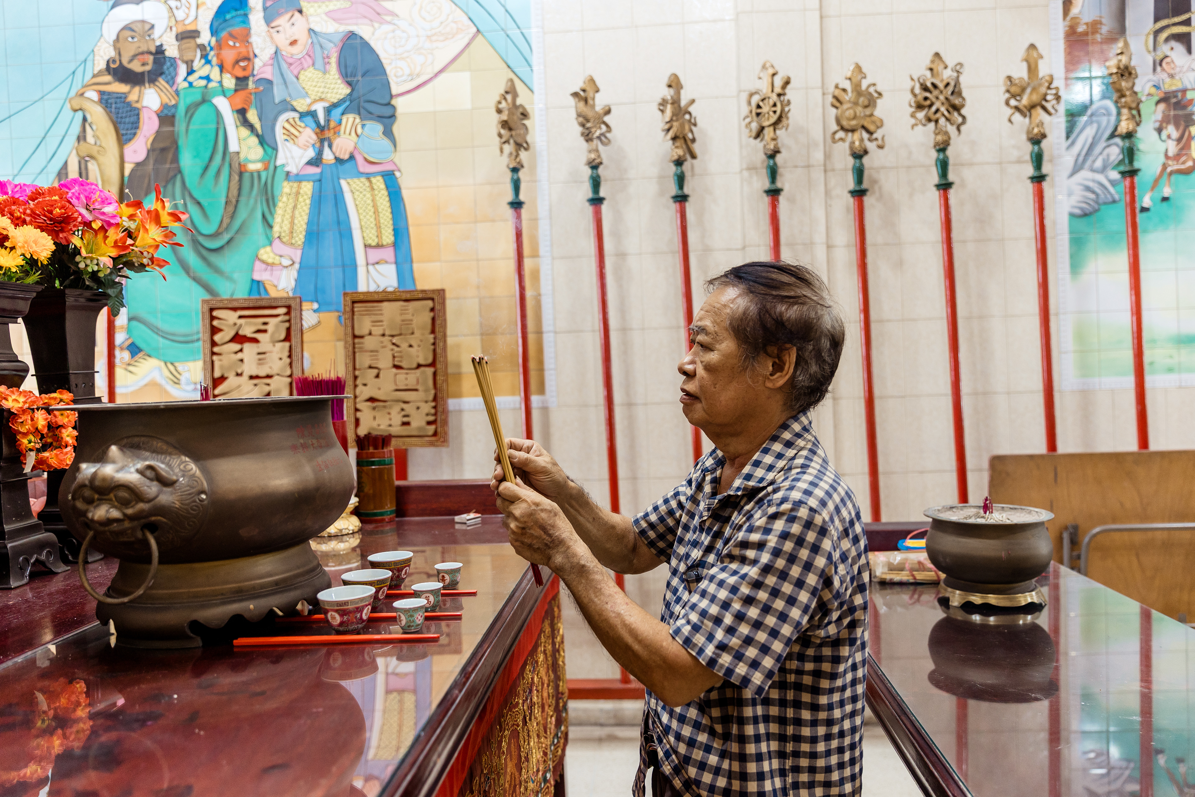 Juan Tam prays at Casco Antiguo, a temple of the Tung Hing Tong Benevolent Society in Panama City’s Chinatown.