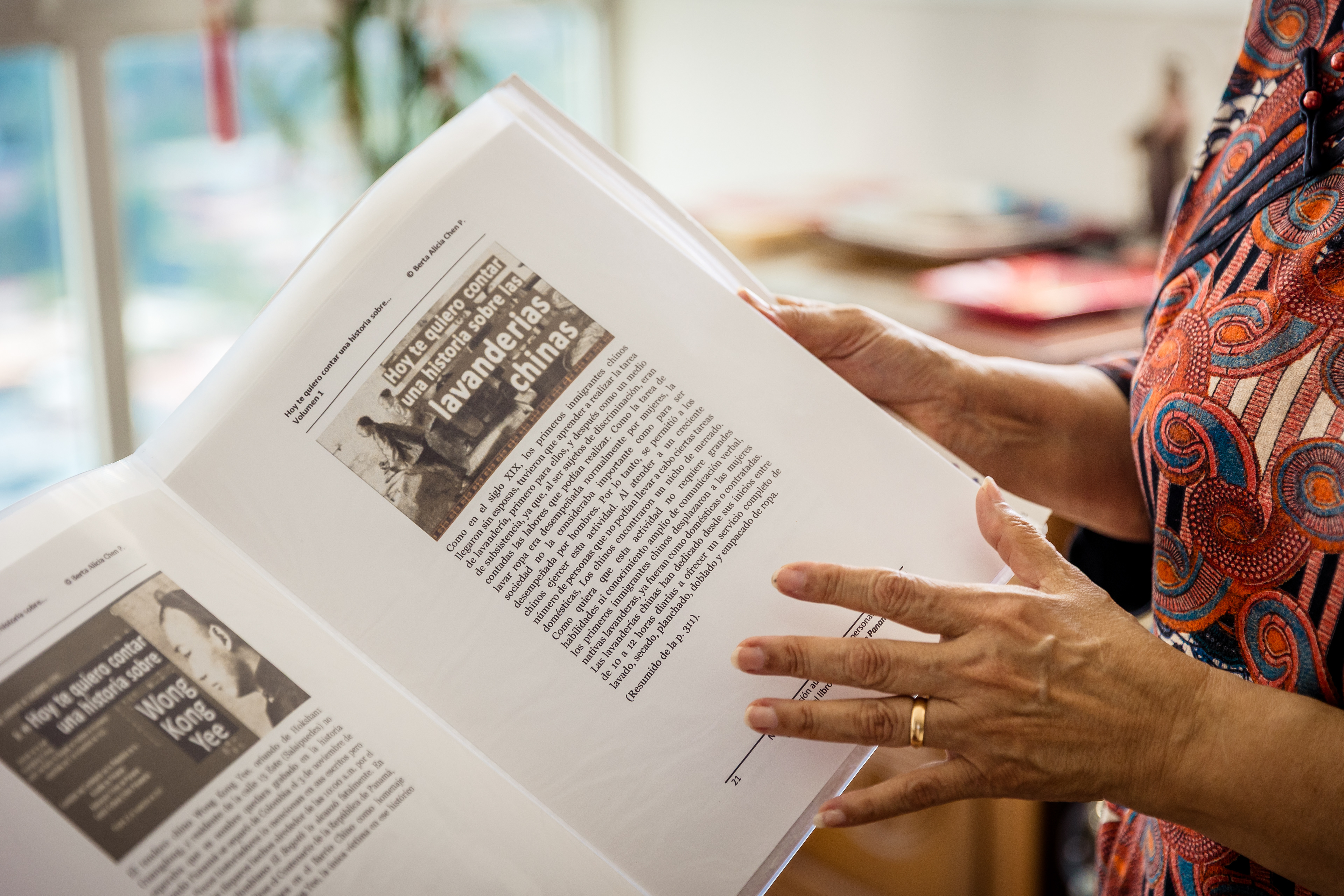 Berta Chen,author, editor, translator, entrepreneur, and historian, holds one of her published books on the history of the Chinese community in Panama. Photographed at her home in Panama City. July 21, 2025.