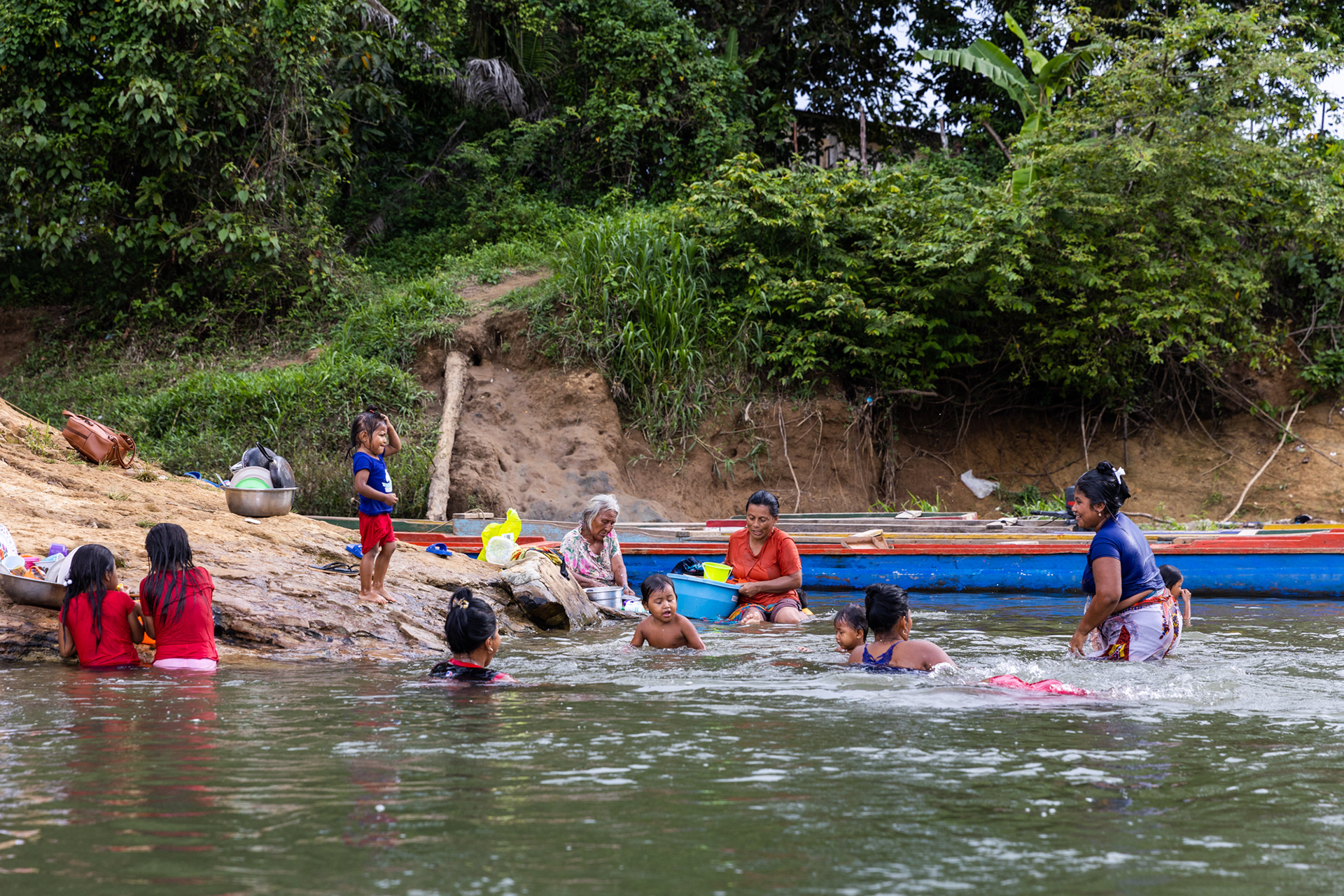 Emberá-Wounaan community members go about their daily routines on the Turquesa River, their lifeline for water and survival.