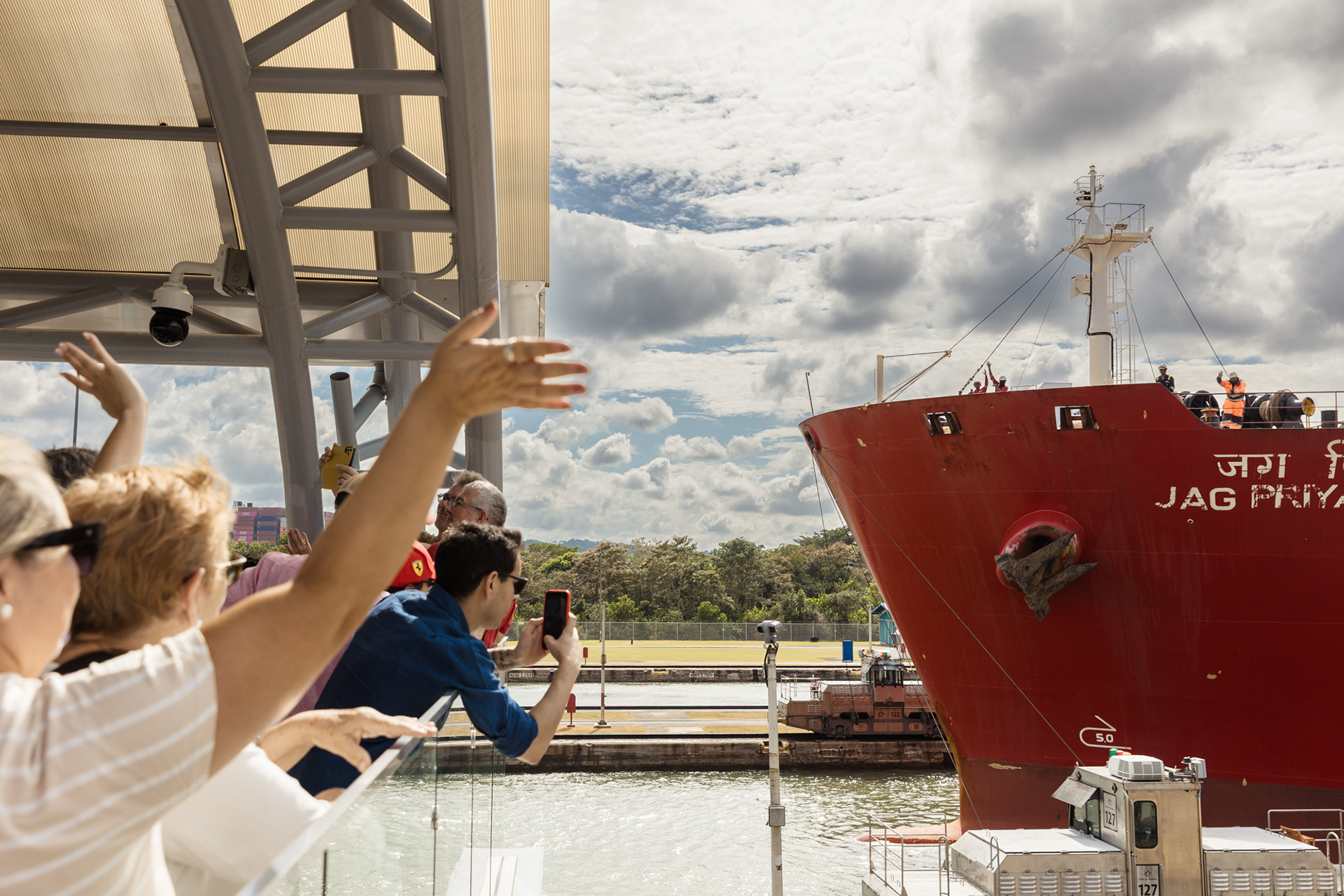 Tourists at the Miraflores Visitor Center watch a vessel navigate the Panama Canal on February 13, making their way toward the Pacific Ocean. Miraflores locks in Panama city, Panama.