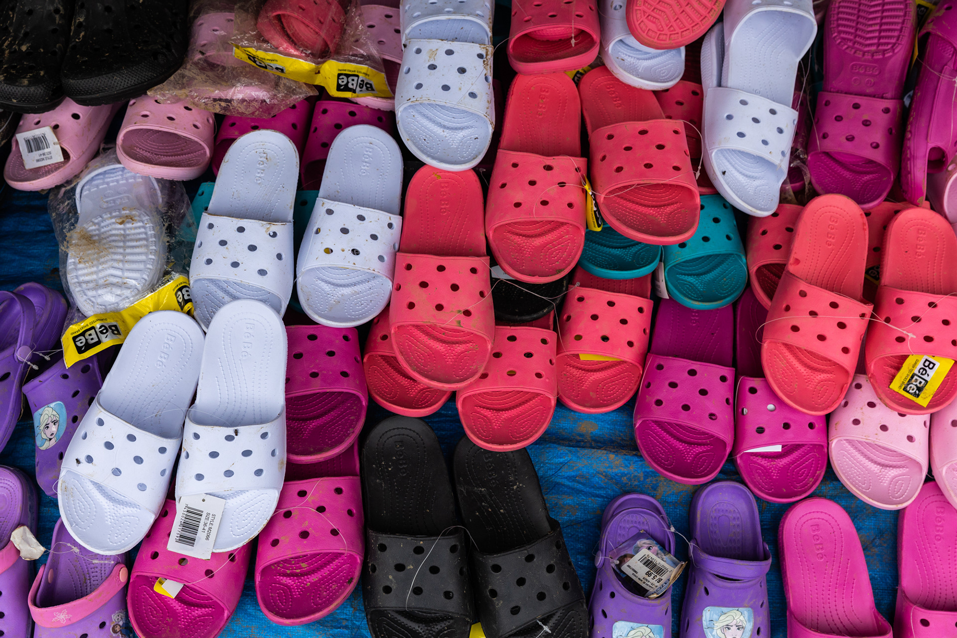 A selection of colorful crocs, the most popular footwear choice for migrants passing through.