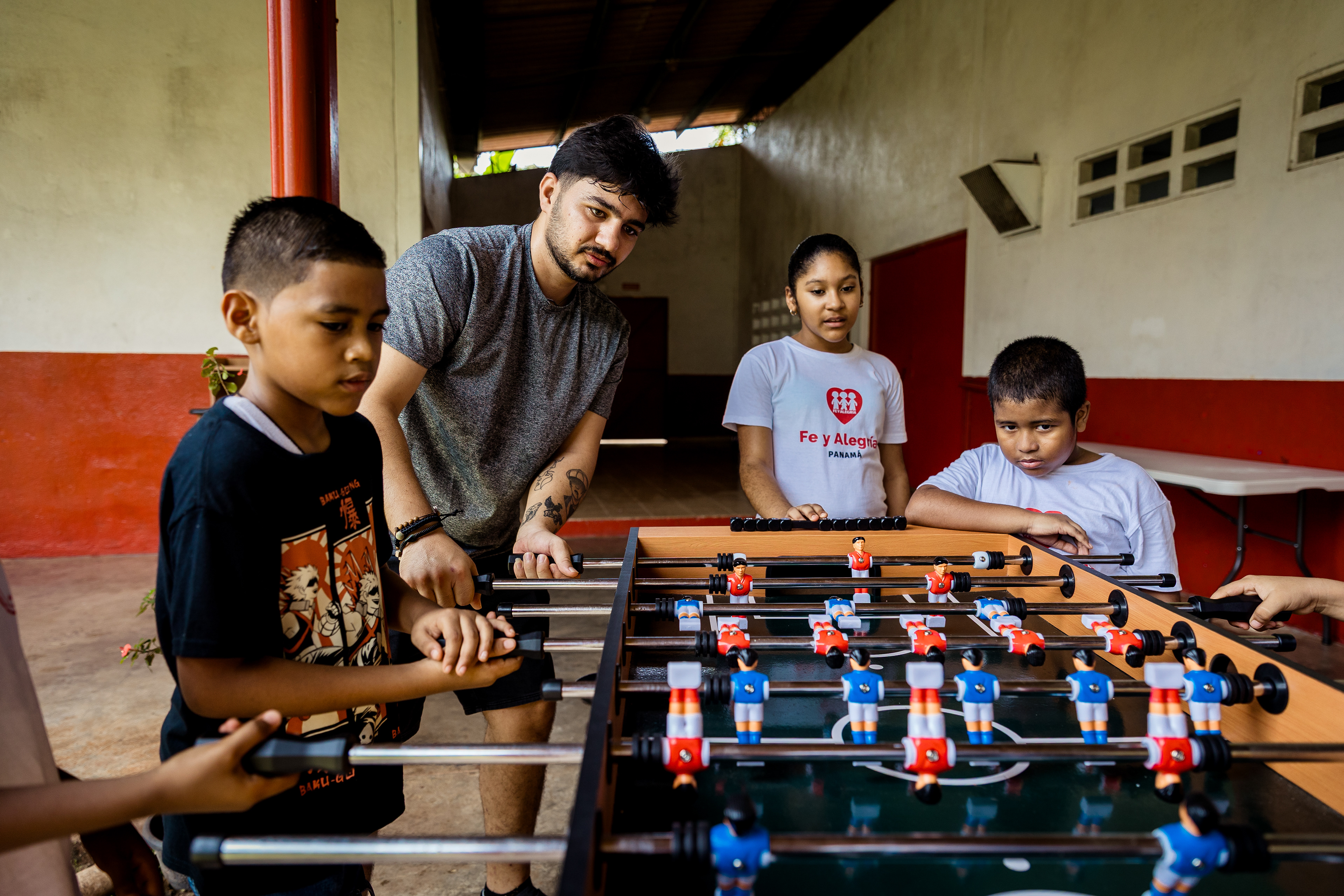 Hidayat Zazai, 34, originally from Afghanistan, plays with children during a family event at the Fe y Alegría shelter, an organization that has taken in some of the migrants expelled from the U.S. and flown to Panama under the Trump administration’s 2025 deportation policy. Panama City, Panama. July 26, 2025.