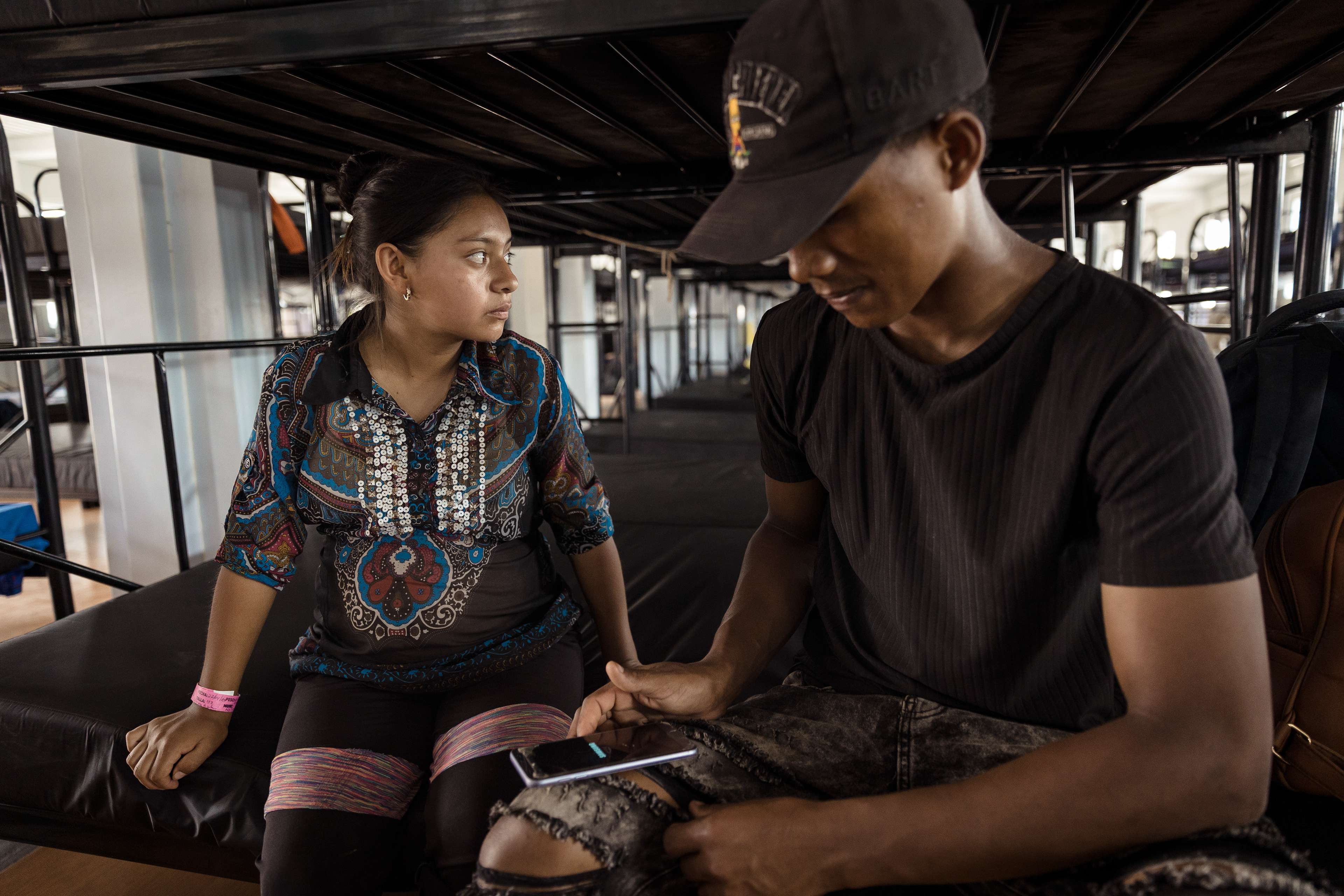 A young couple, seven-months pregnant, both Ecuadorians, at a migrant camp in San Vicente, Panama after walking across the Darien jungle. Darien, Panama.