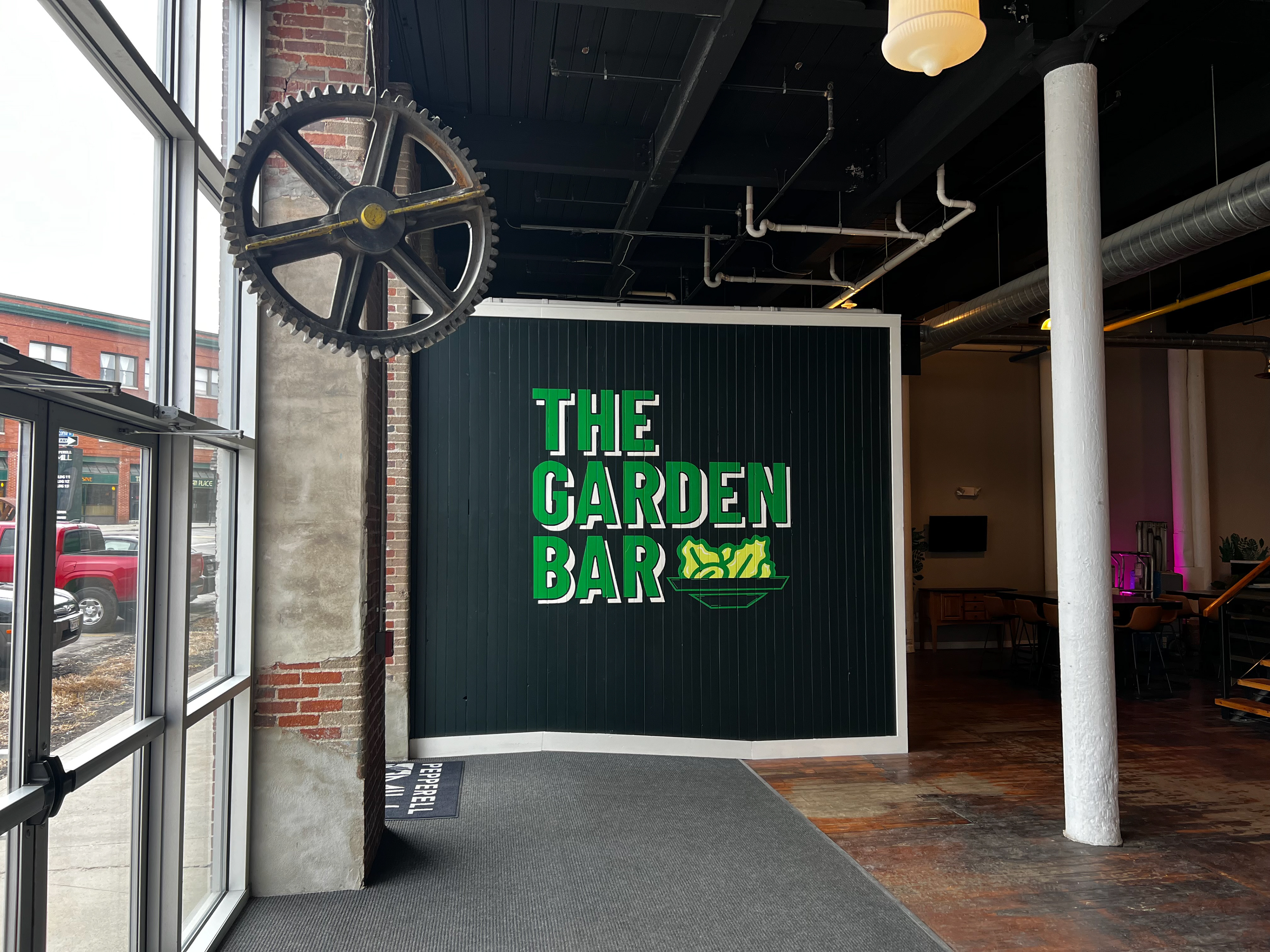 Freehand logo painting for The Garden Bar in Pepperell Mill Campus.
