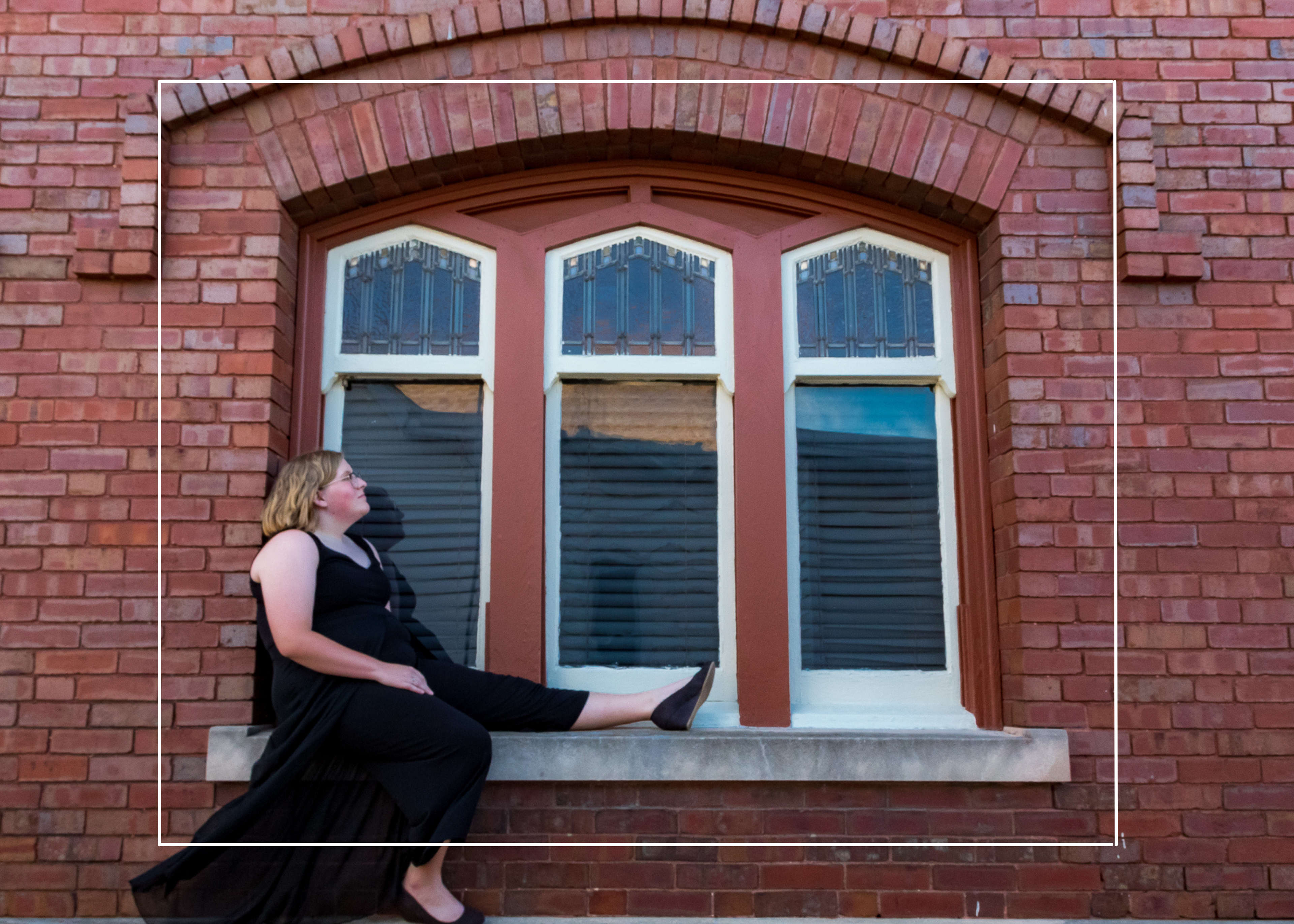 Mackenzie is framed by the architecture of the window here. You are drawn to her in the photo by this natural frame.