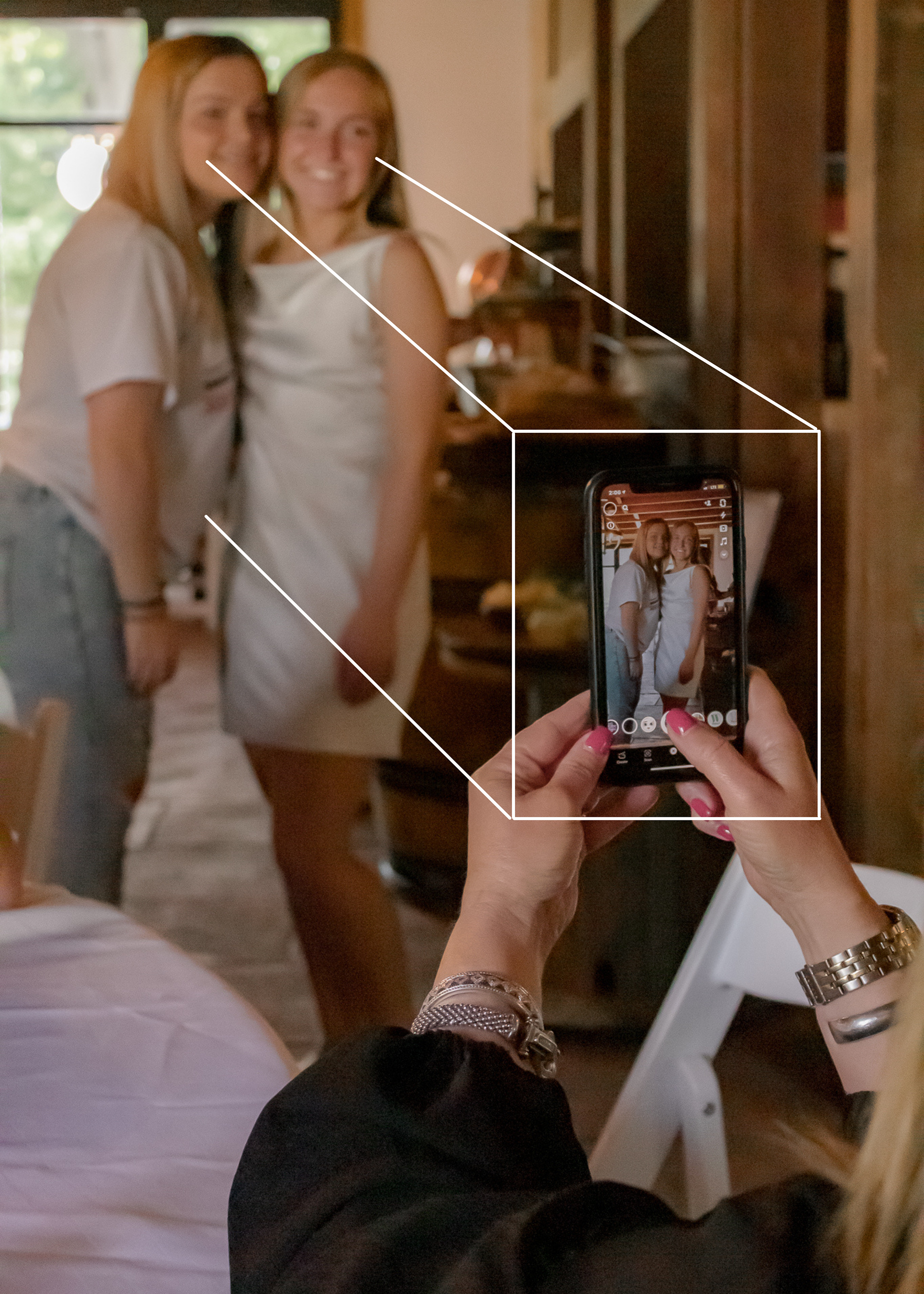 I love to use phones as a framing method during my shoots. Notice how your eyes are drawn into the moment of this picture.
