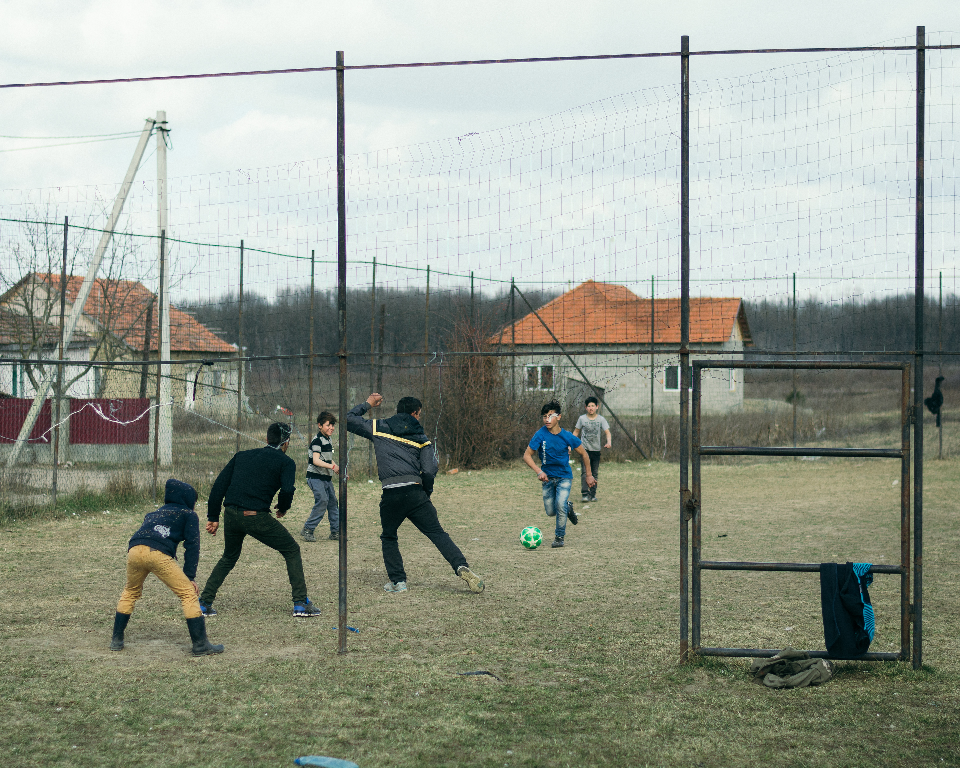 Kids playing football outside. Ukraine, 2019.