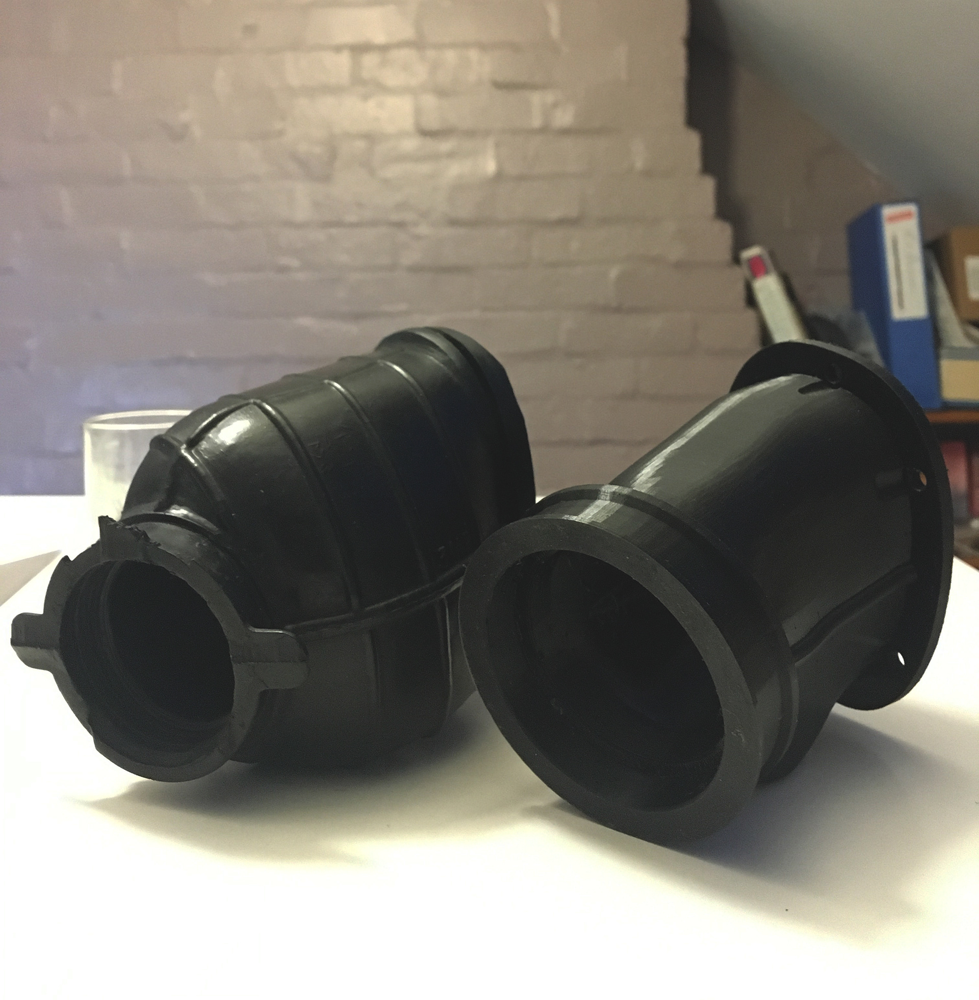 Left - OEM Part designed with a much smaller flange for original carburettor. Right - Final custom design suited for larger Carburettor