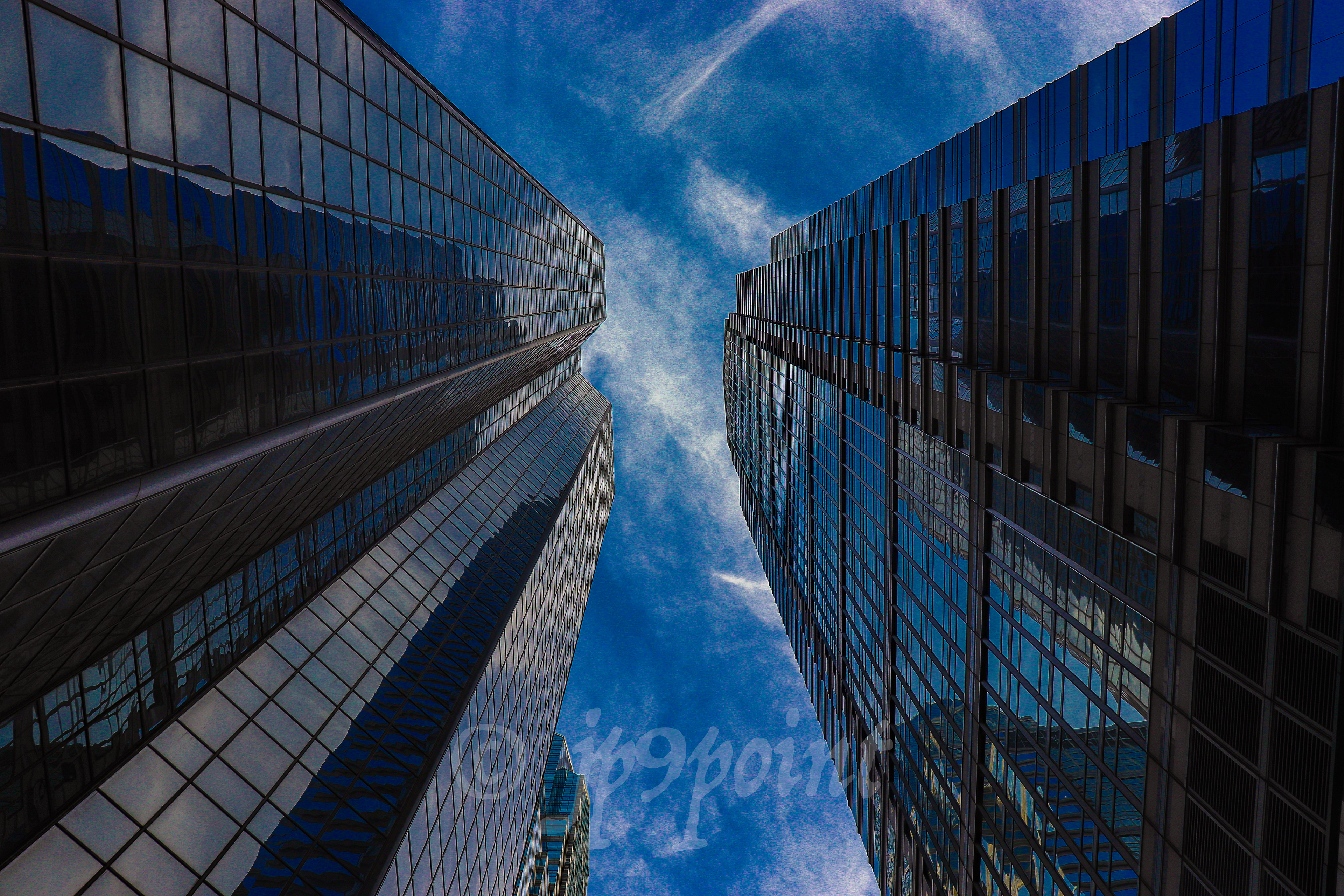 Windows reflect the deep blue sky.