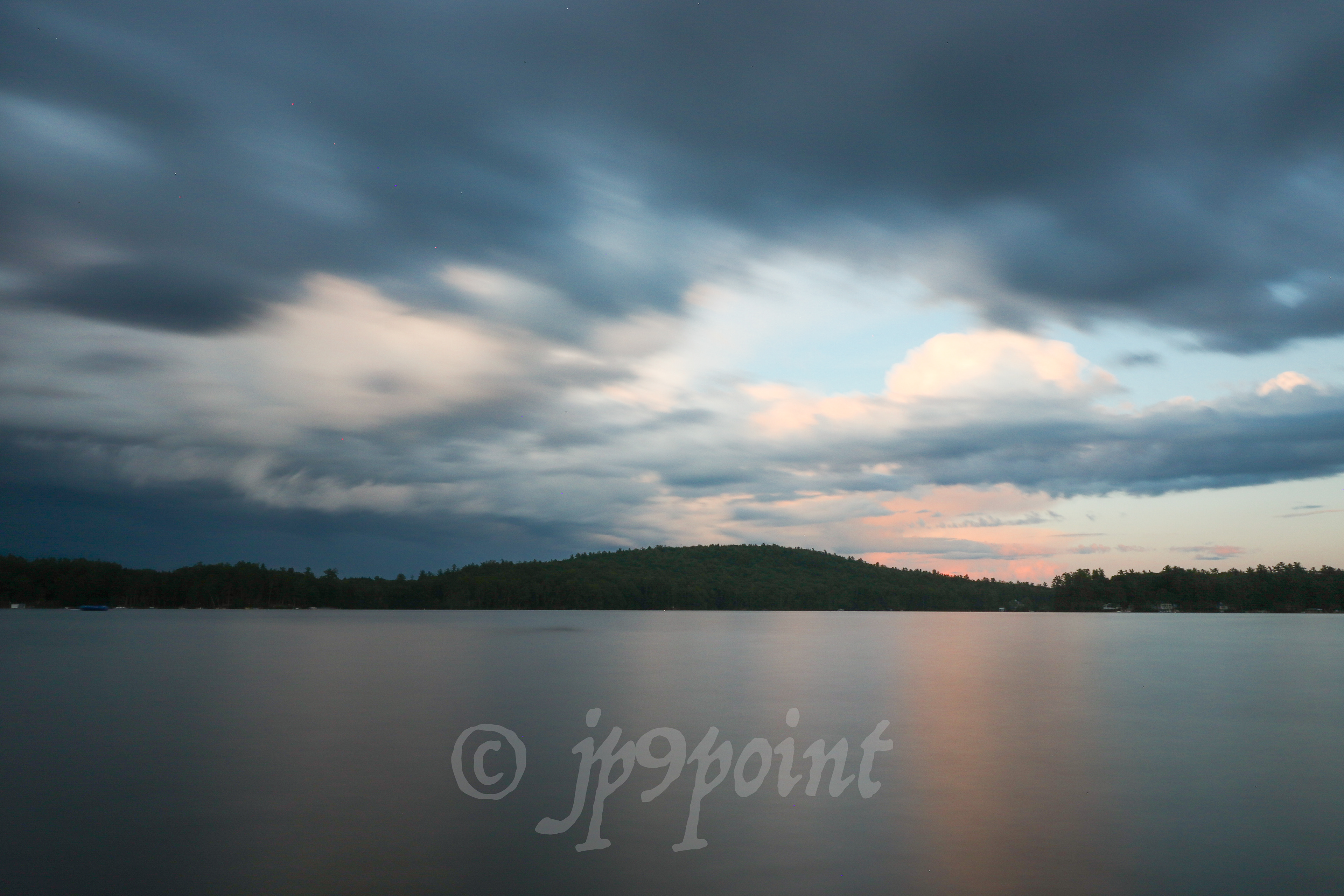 Stormy night came with a little orange cloud over Lake Winnipesaukee, New Hampshire.