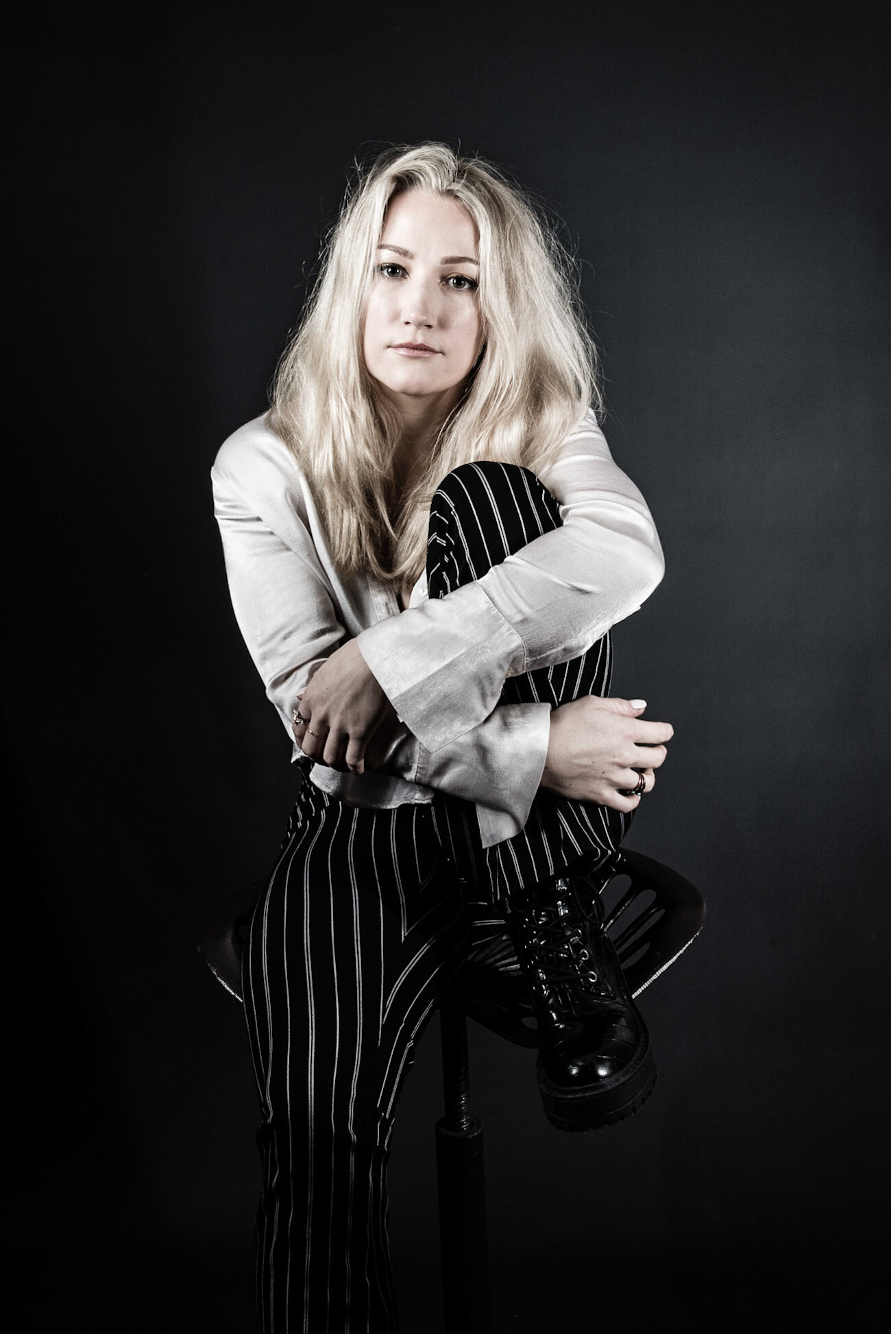 Darcy Winter, Music promotion shoot, On location with portable studio, using black and greay backdrops with Pika 200 and the Citi 400 by Pixa pro. Promostional brnading shoot portrait by Xavier Clarek, XC phtography