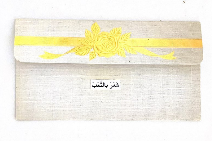 Detail (text collage and found object) — Text in image (Arabic → English): 'He felt tired'
