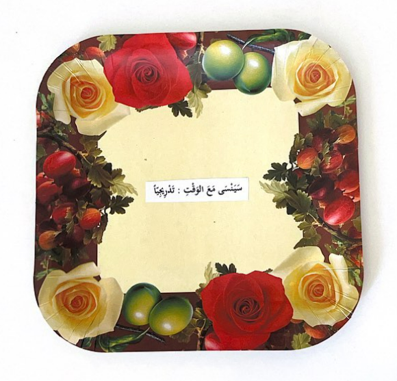 Detail (text collage and found object) — Text in image (Arabic → English): 'He will forget with time: gradually'