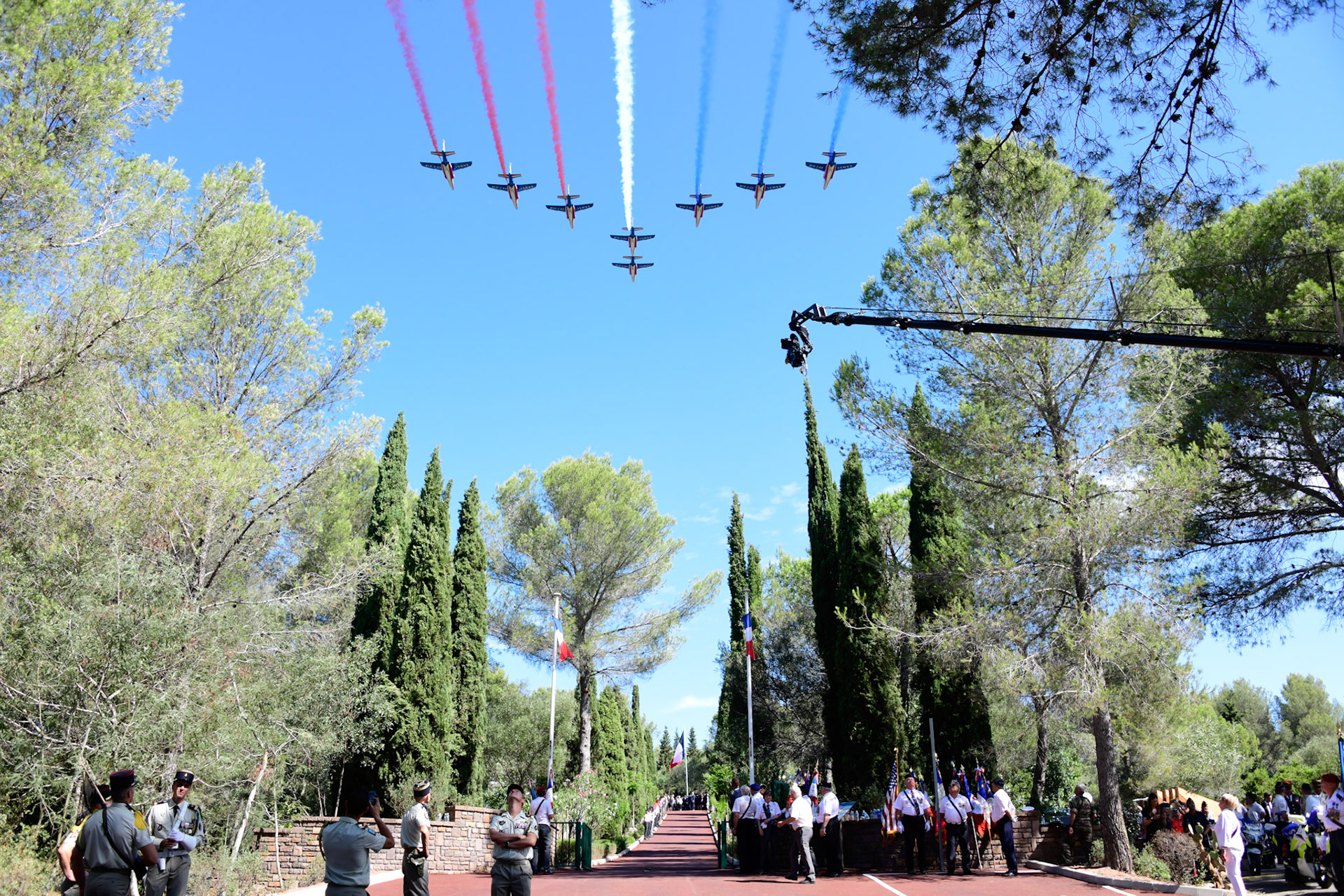 French President Emmanuel Macron (C) reviews troops during a ceremony marking the 75th anniversary of the Allied landings in Provence during World War II, in Saint-Raphael, south eastern France, on August 15, 2019.