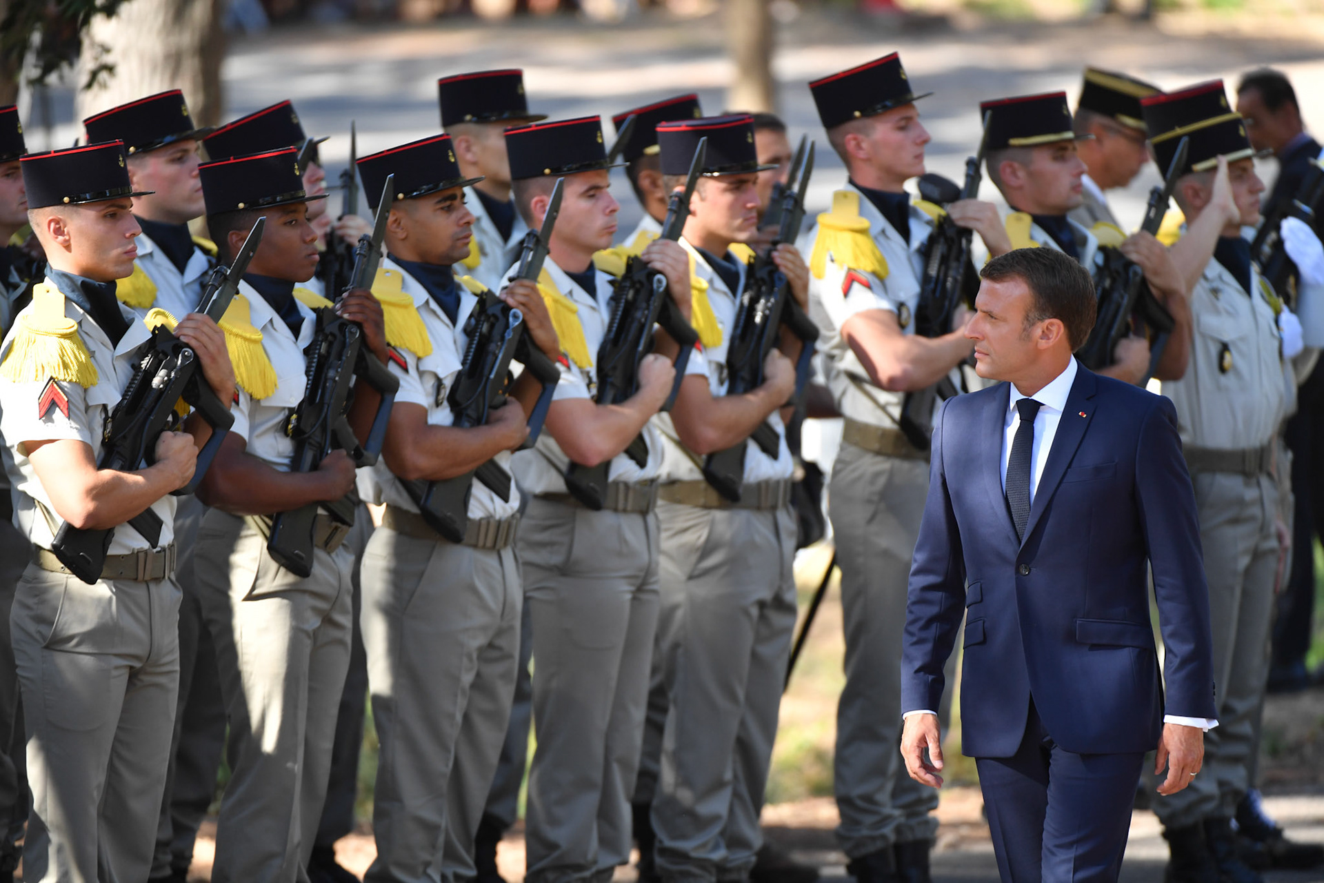 French President Emmanuel Macron (C) reviews troops during a ceremony marking the 75th anniversary of the Allied landings in Provence during World War II, in Saint-Raphael, south eastern France, on August 15, 2019.