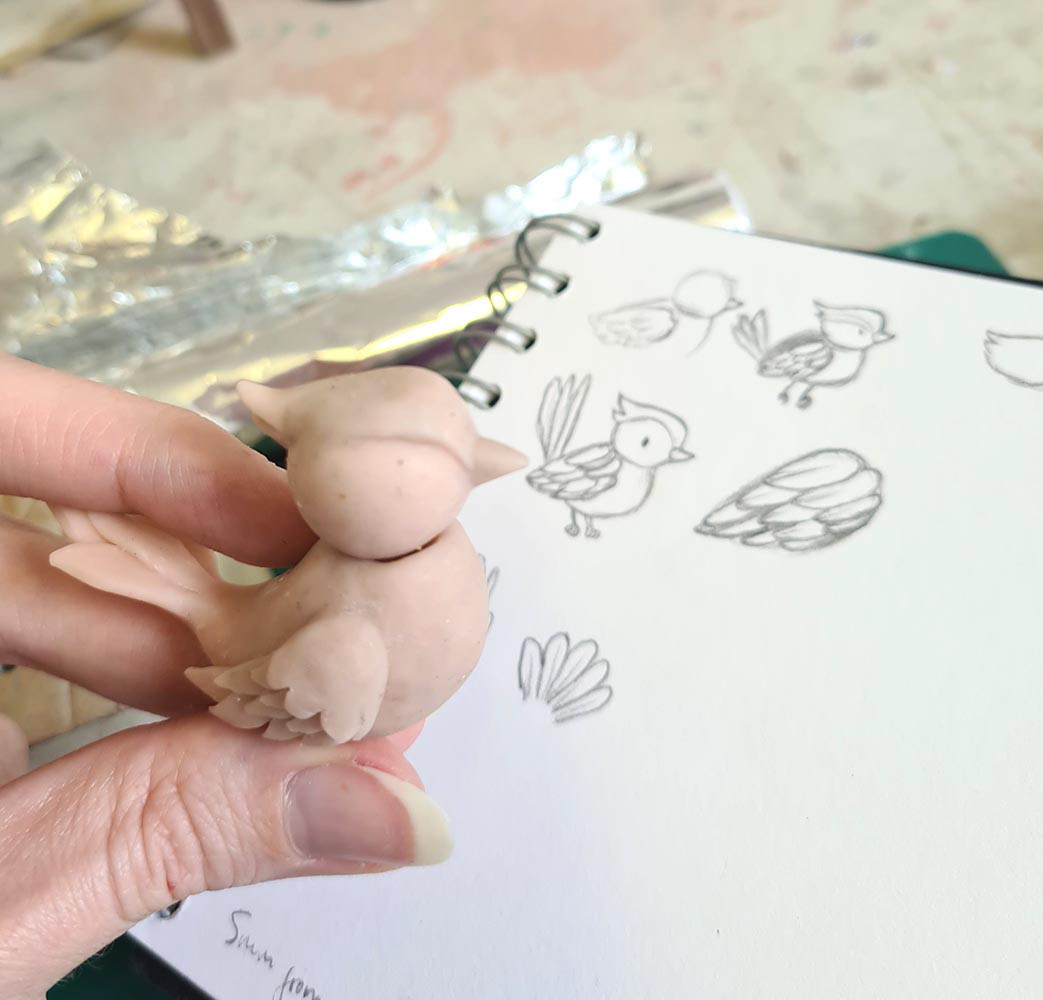 The birds were made out of polymer clay and wire and were primarily designed by me with input from the director.